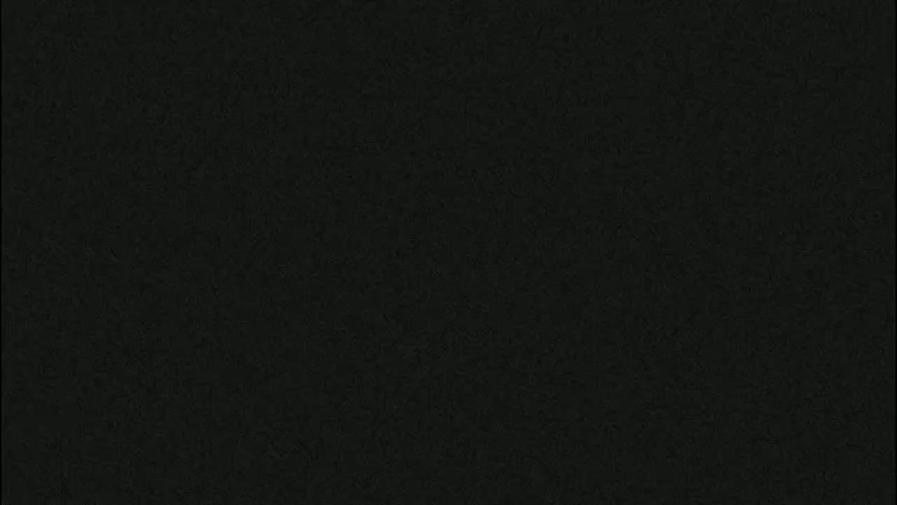 The image shows a dark-grey textured surface.