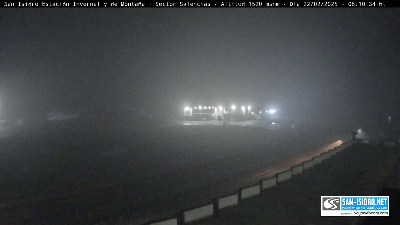 A foggy, dimly lit roadside rest stop is visible at night.