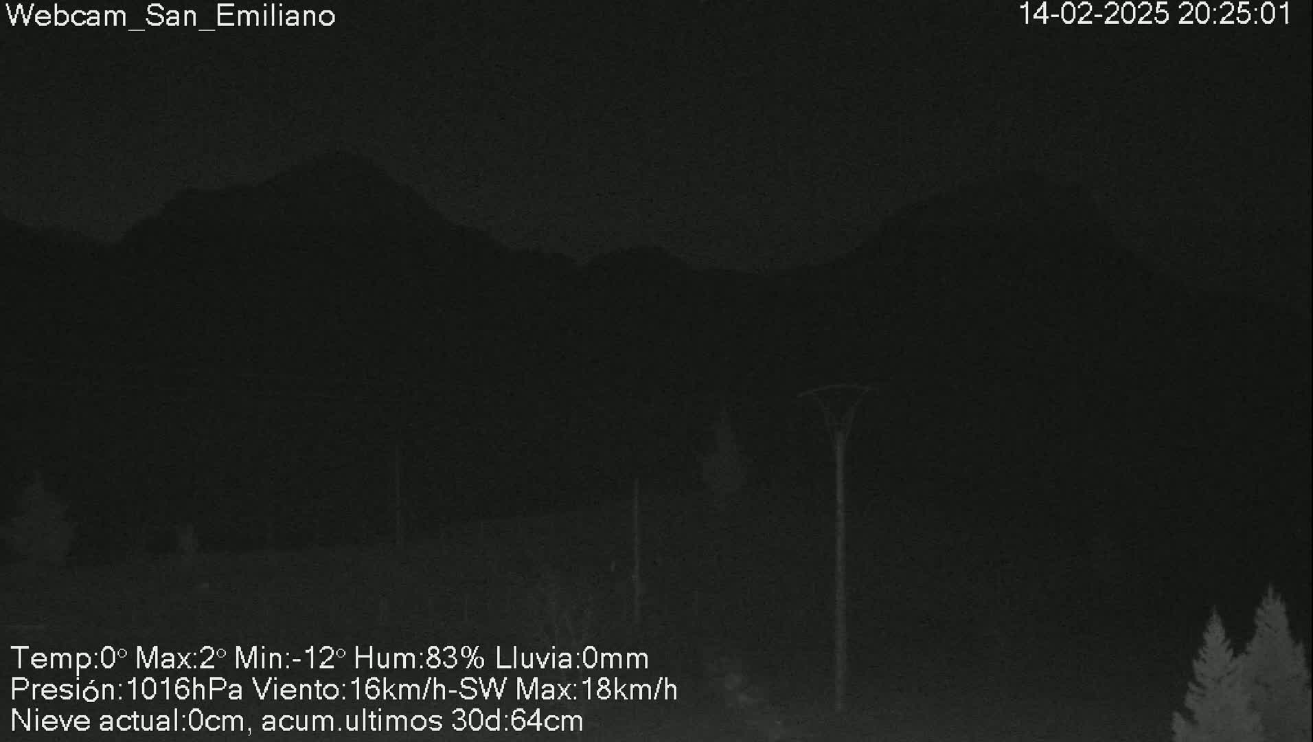 A nighttime, low-light view of dark mountains under a cloudy sky with no rain.