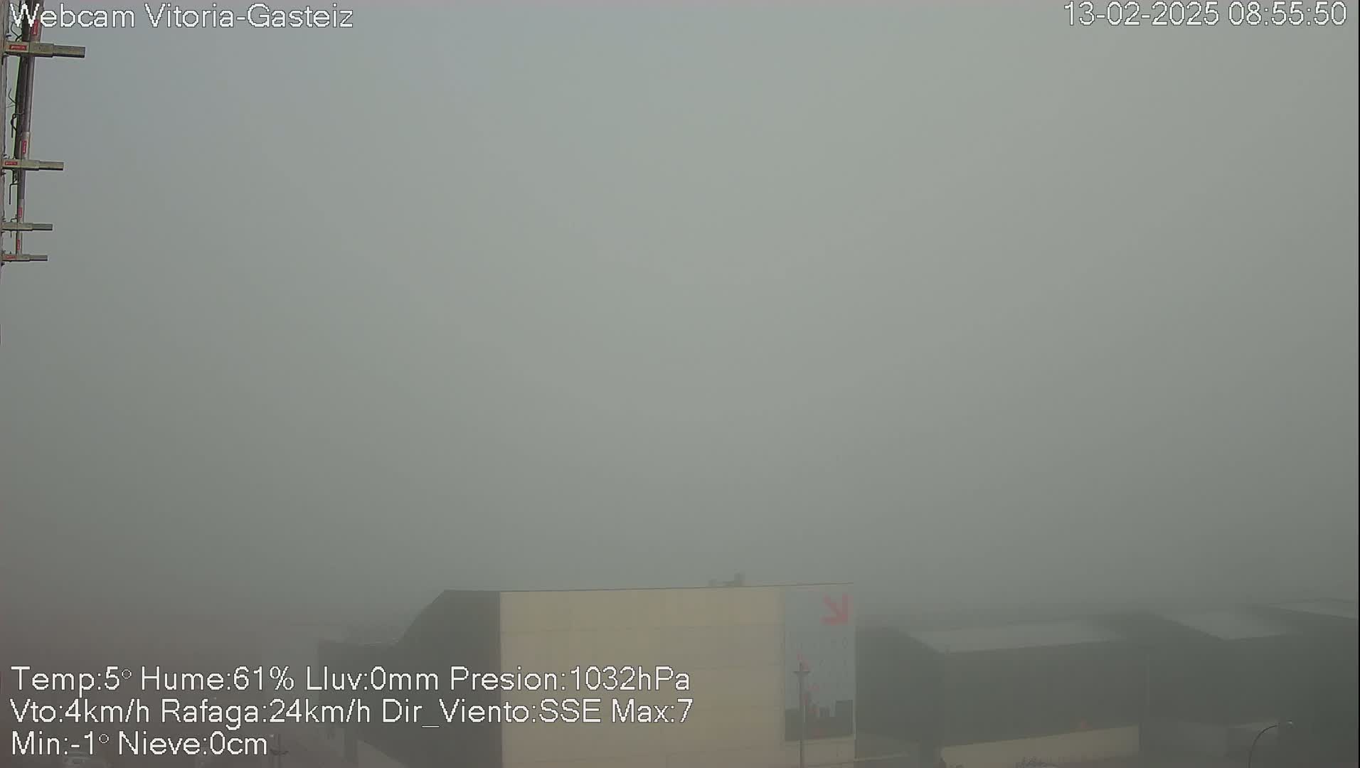 A thick fog obscures the view of several buildings in the distance.