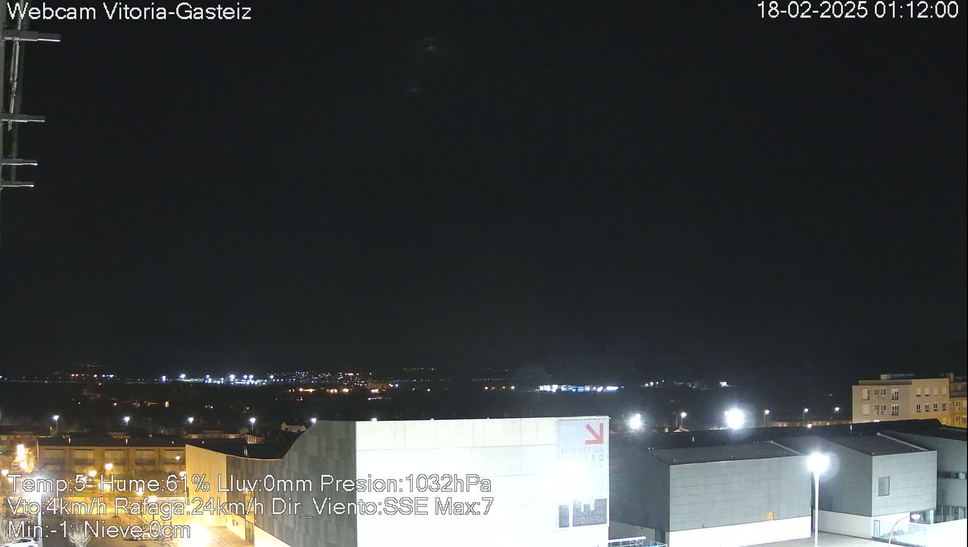 A nighttime view of a city with low-light illumination under a dark, clear sky.