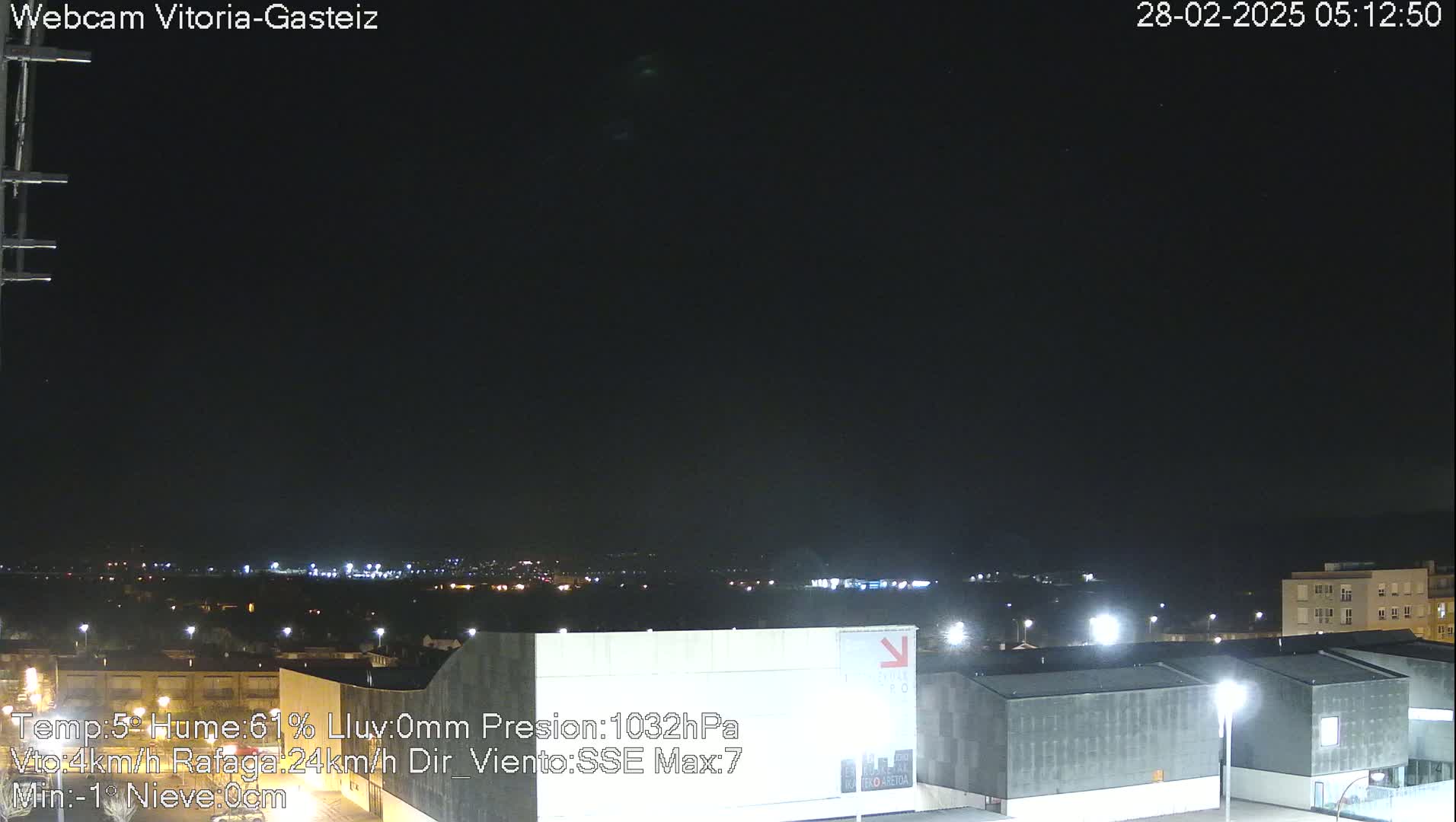 A nighttime view of a city skyline under a clear, dark sky.