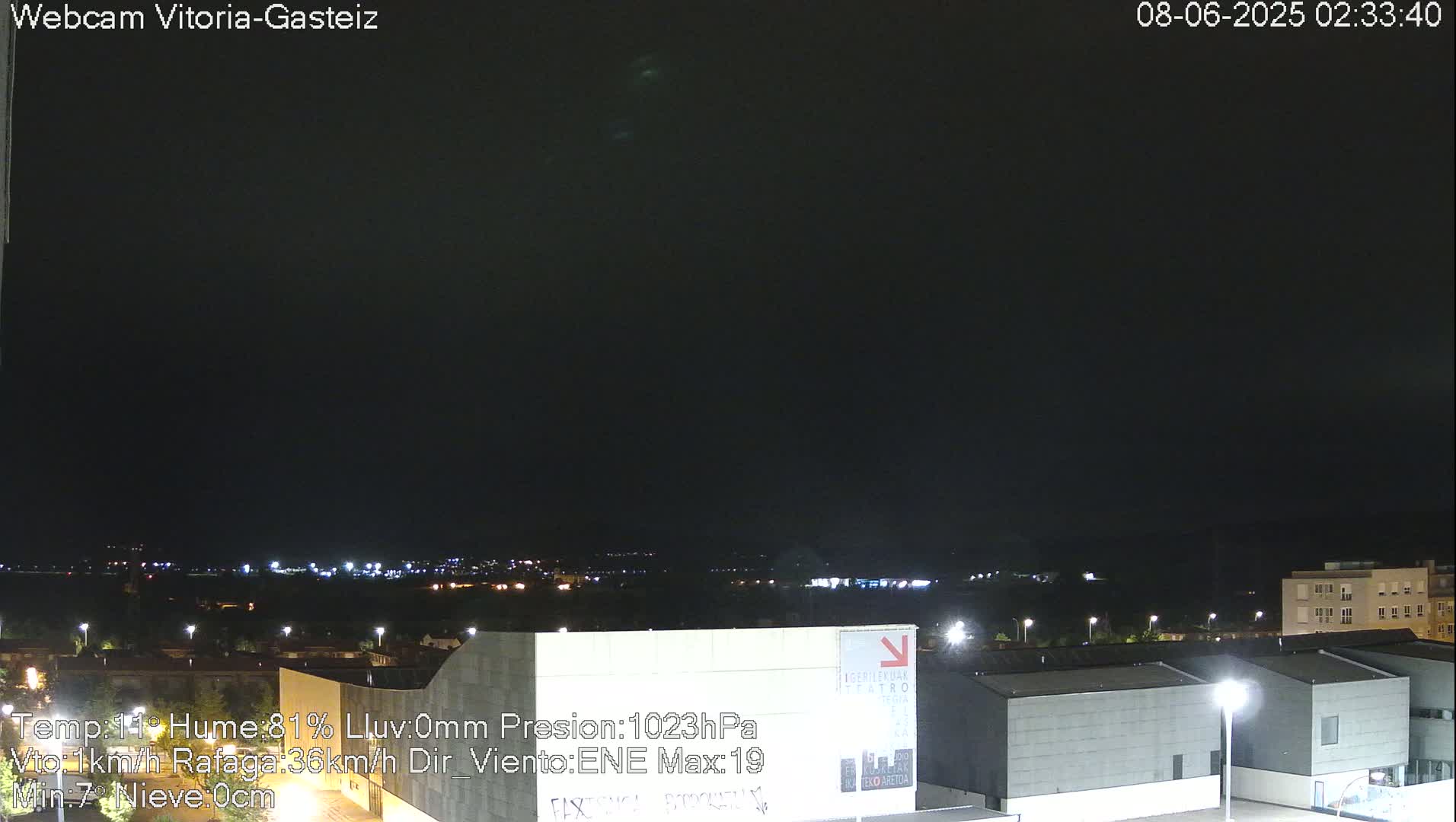A nighttime view of a city with a dark, overcast sky.