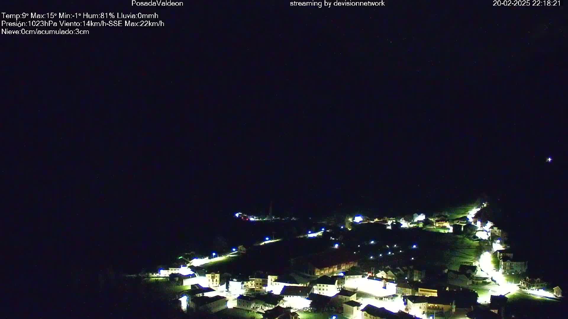 A small village illuminated at night under a clear, dark sky.
