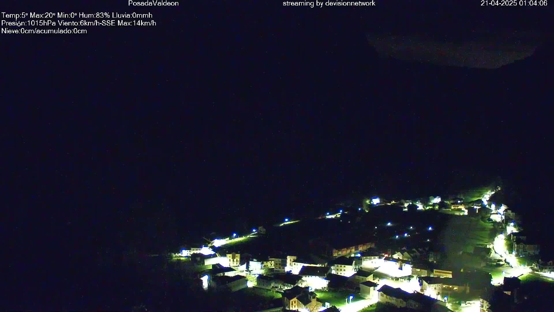 A small village illuminated at night under a dark, clear sky.