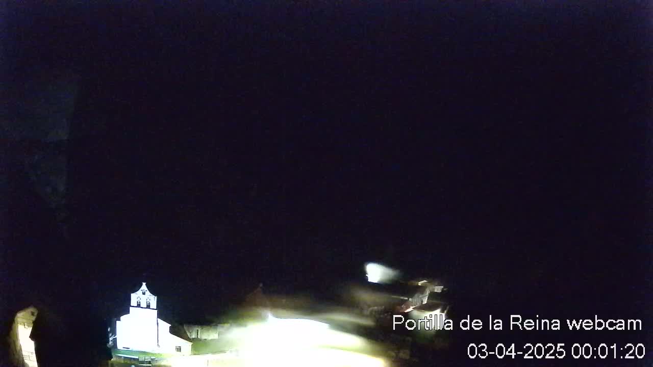 A dimly lit, nighttime scene shows a partially visible building, possibly a church, under a dark, clear sky.
