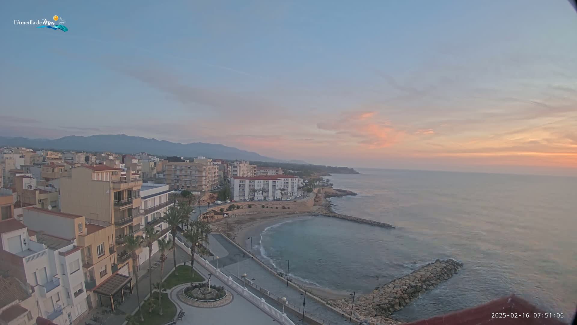 A coastal town at sunrise, with pastel-colored skies over calm waters and a small, sandy cove.