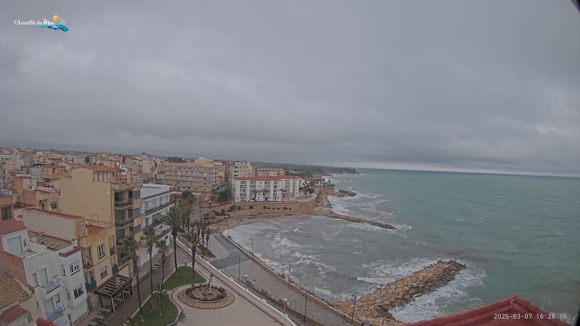A coastal town under an overcast sky, with a somewhat choppy sea visible from an elevated vantage point.