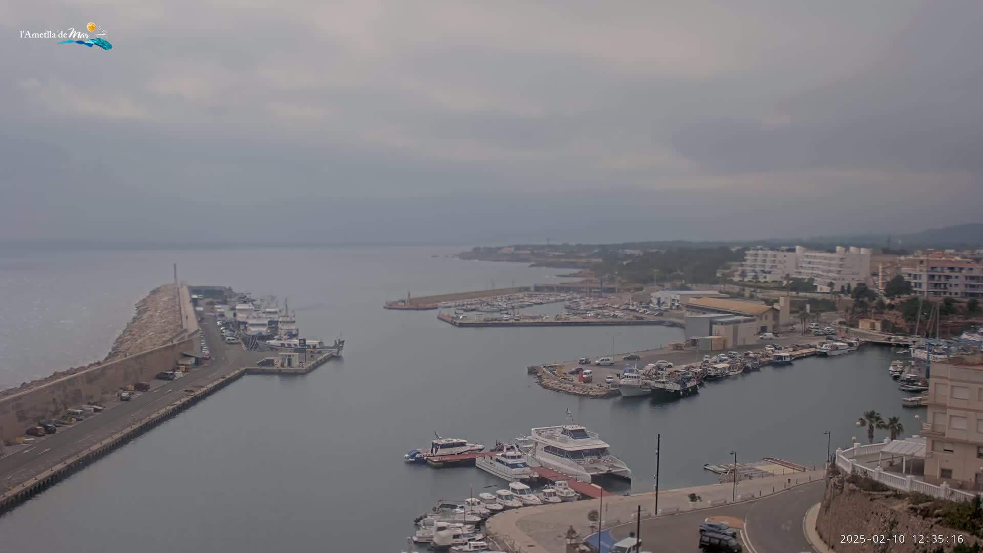 A harbor filled with numerous boats and yachts under an overcast sky.