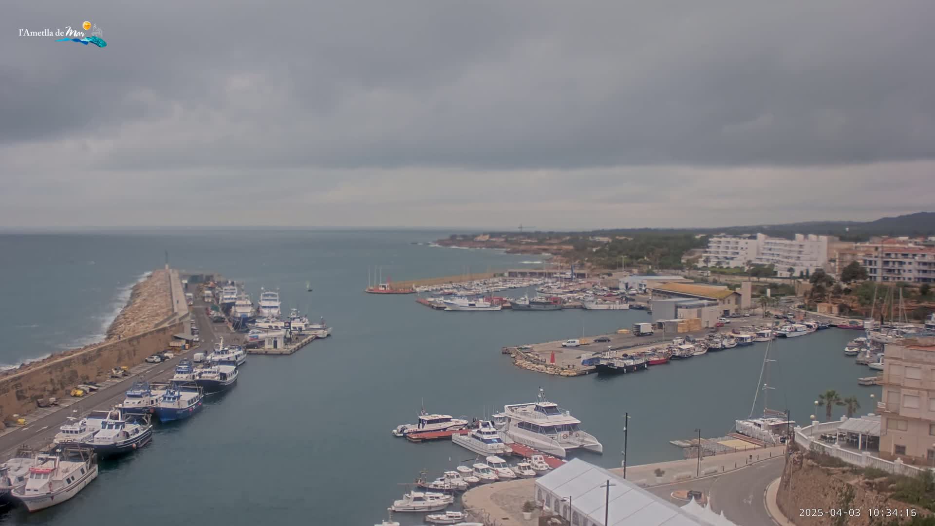 A harbor filled with numerous boats and yachts under an overcast sky.