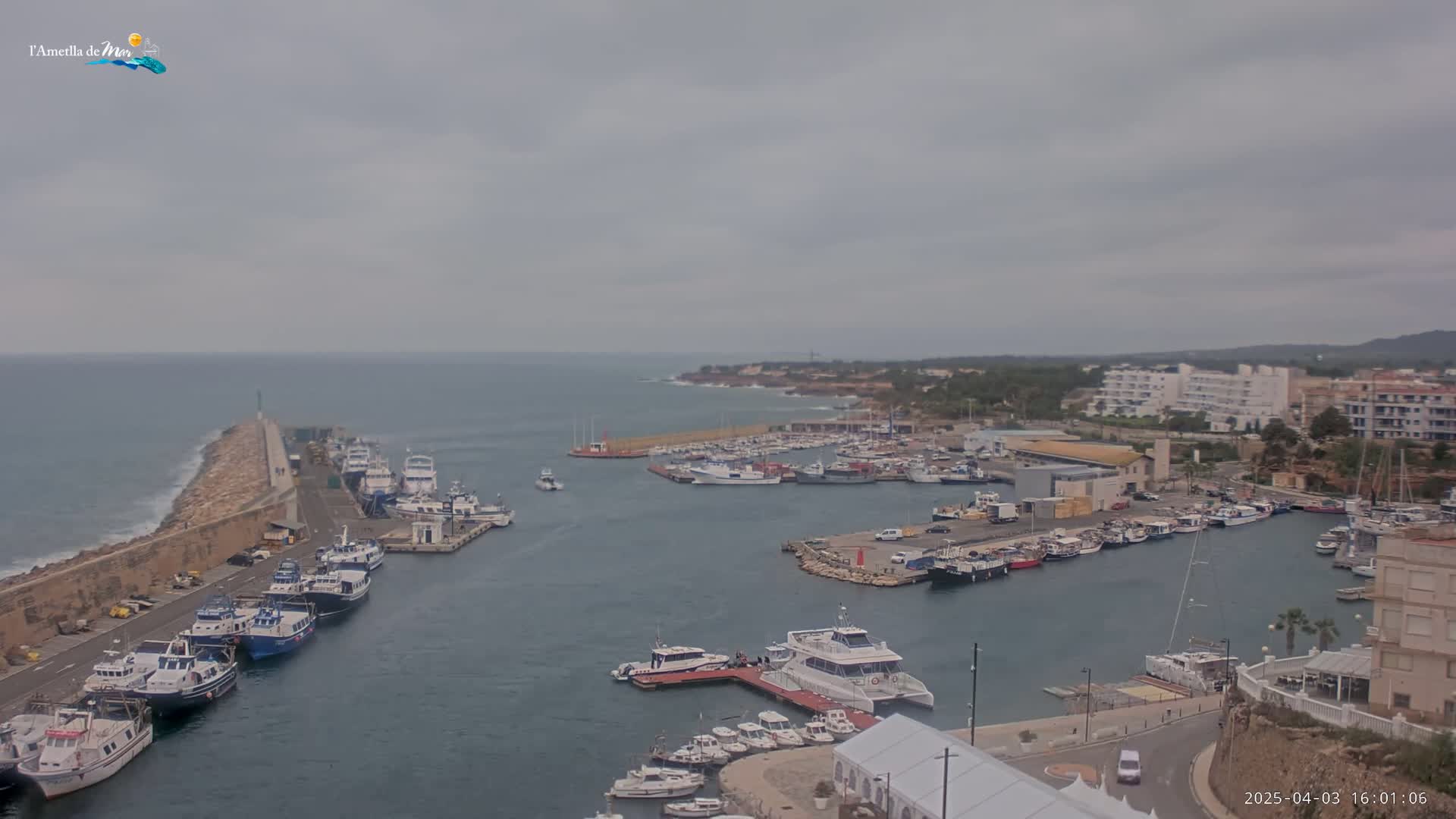 A harbor filled with numerous boats and yachts under an overcast sky.