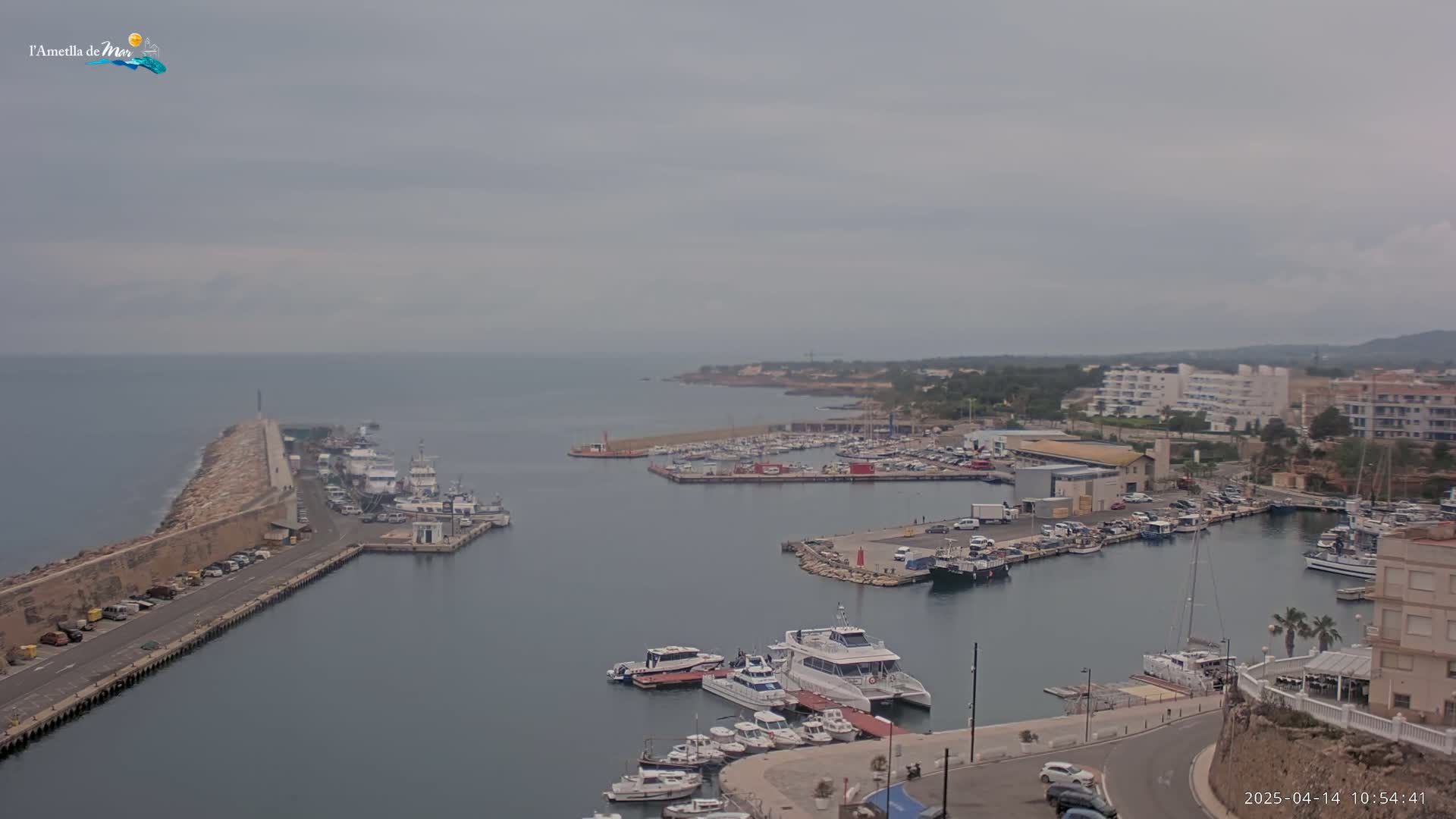 A harbor filled with numerous boats and yachts under an overcast sky.