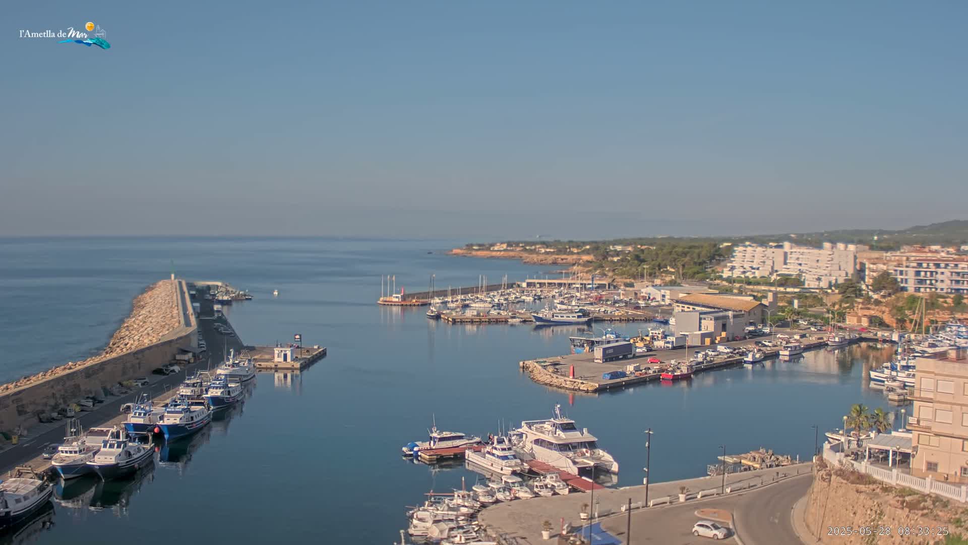 A harbor filled with numerous boats and yachts under a clear, sunny sky.