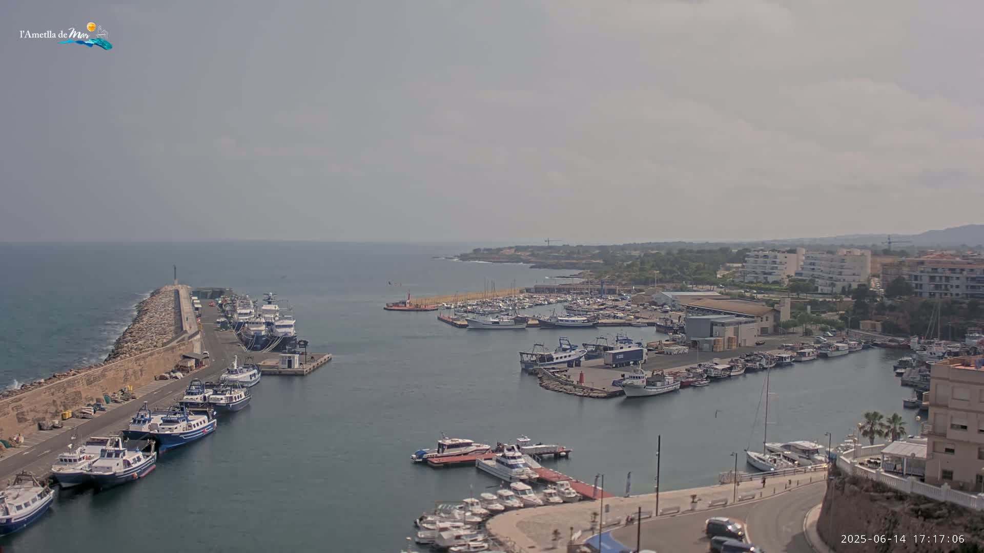 A harbor filled with numerous boats and yachts under a hazy sky.