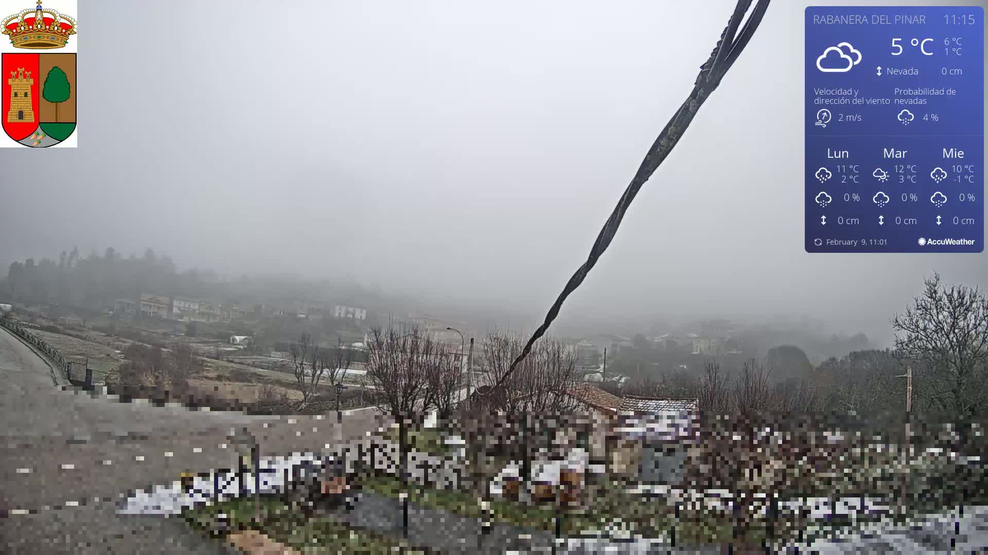 A foggy, snowy scene overlooks a small town and surrounding countryside.