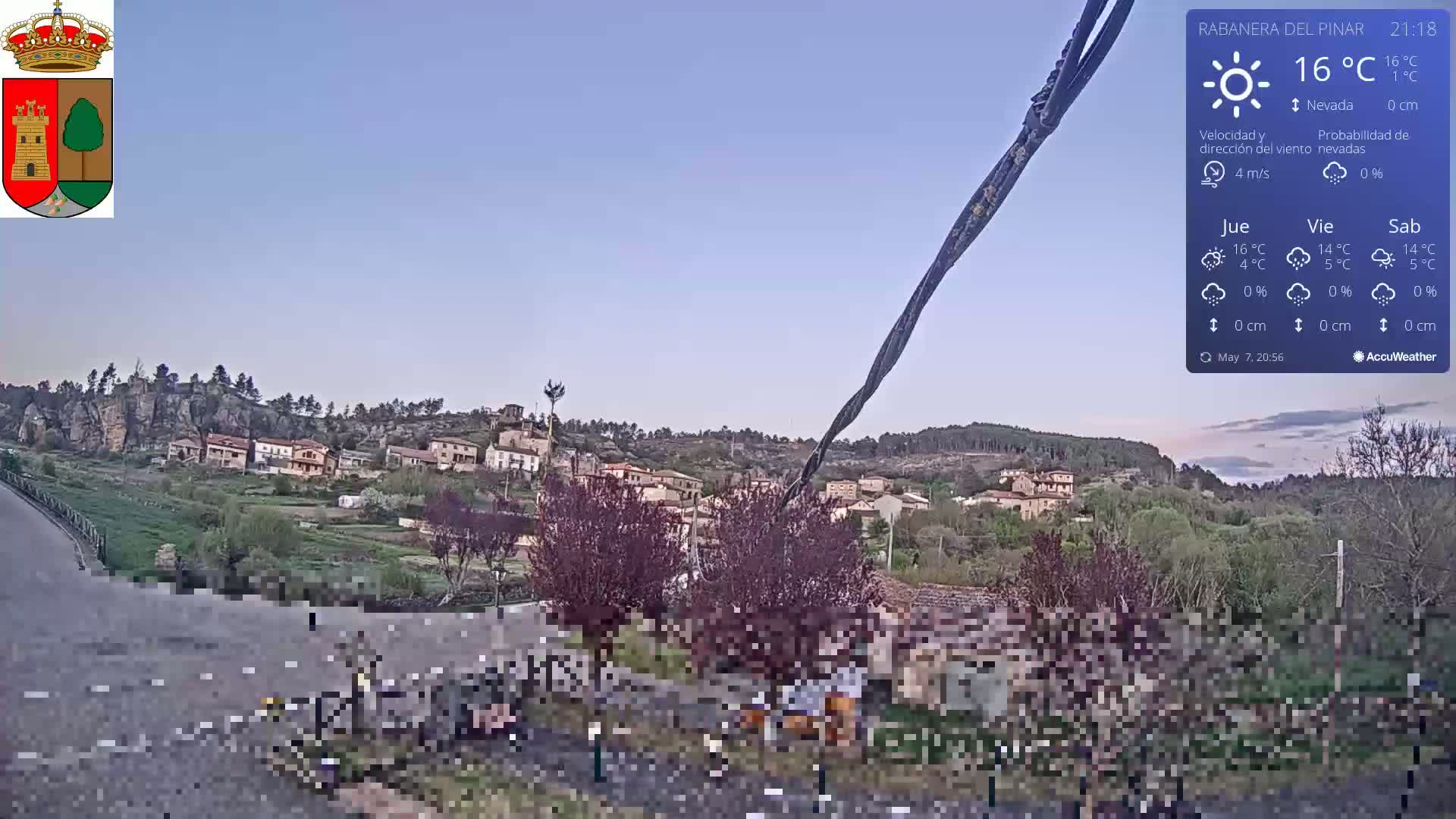 A small village nestled in a hillside setting under a clear, twilight sky.