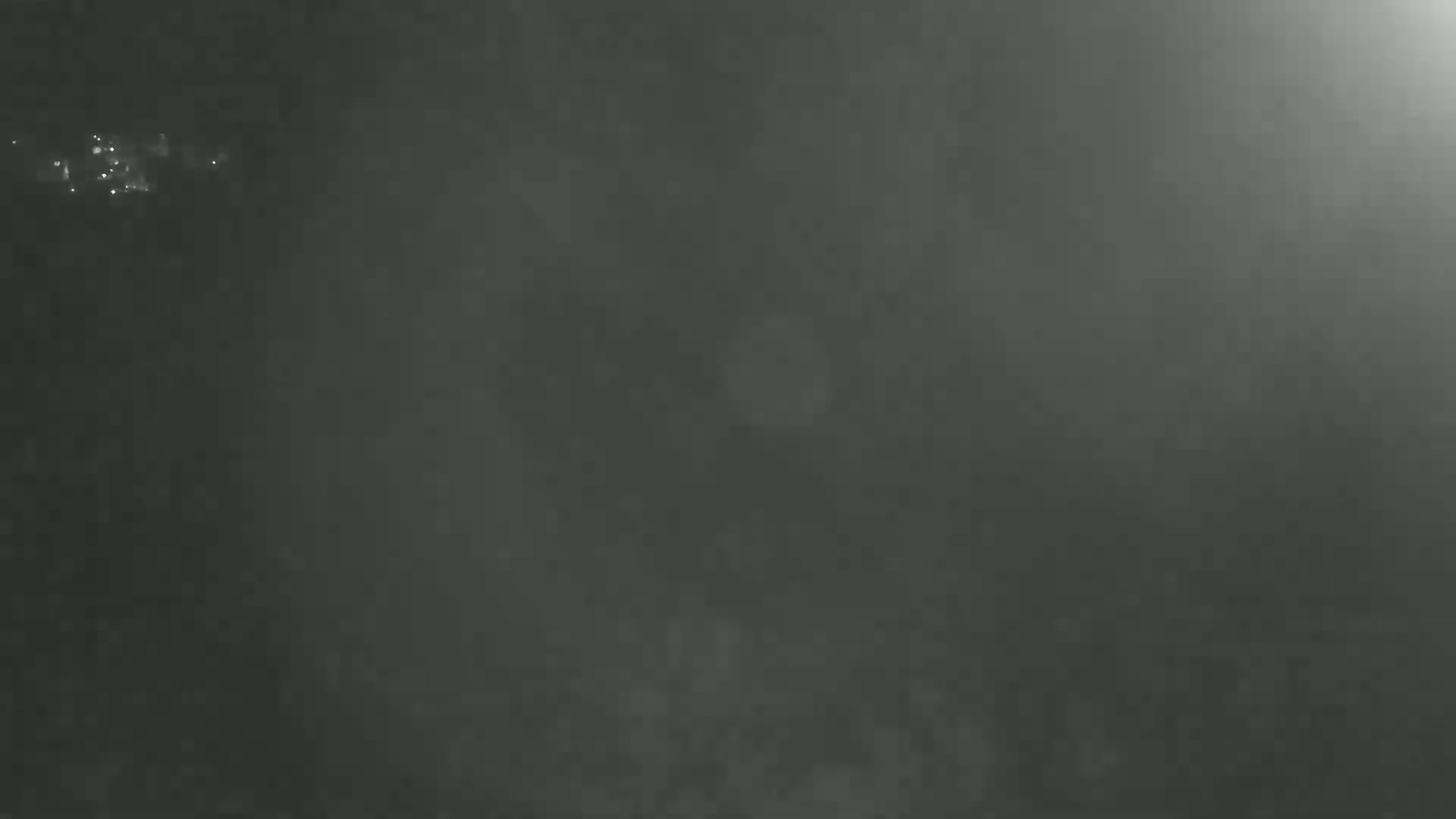 A dark, foggy scene is illuminated by a bright light source in the upper right corner.