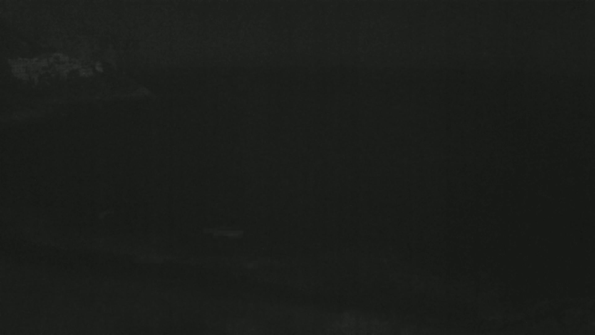A dark, blurry image shows a mostly featureless, dark gray or black surface.