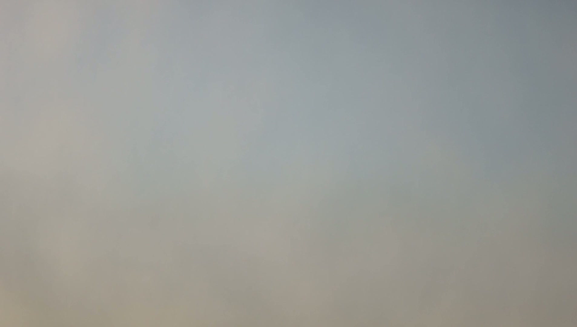 A hazy, light gray sky is visible.
