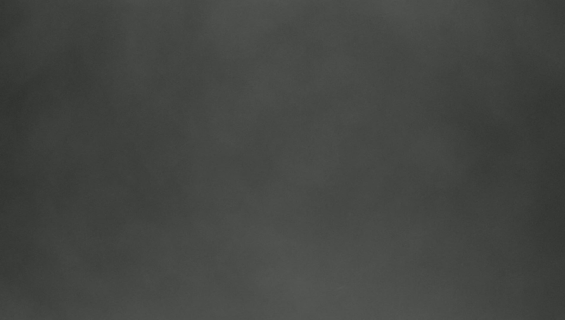 A dark gray, slightly textured surface fills the image.