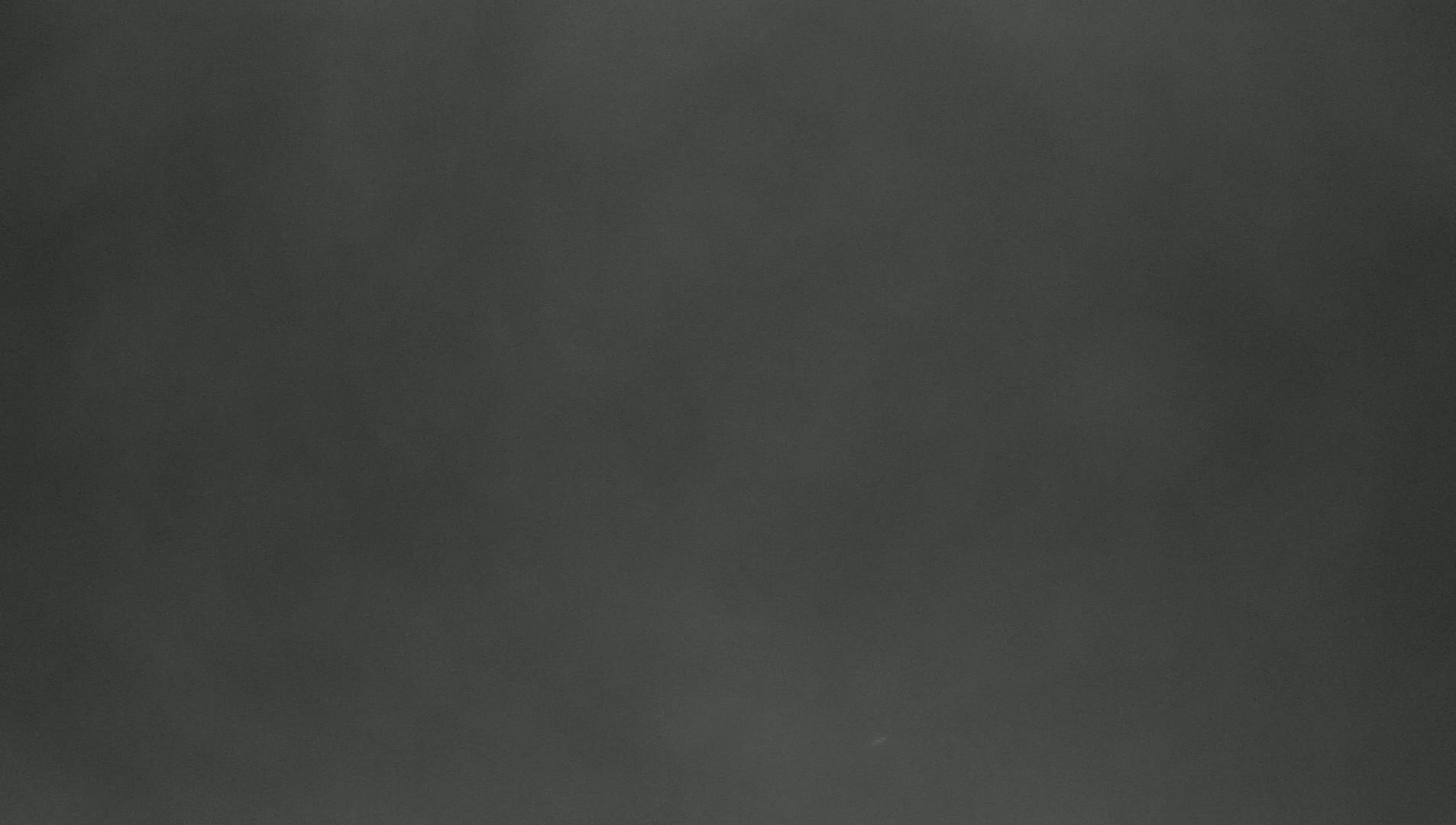 A dark gray, somewhat textured surface is shown.