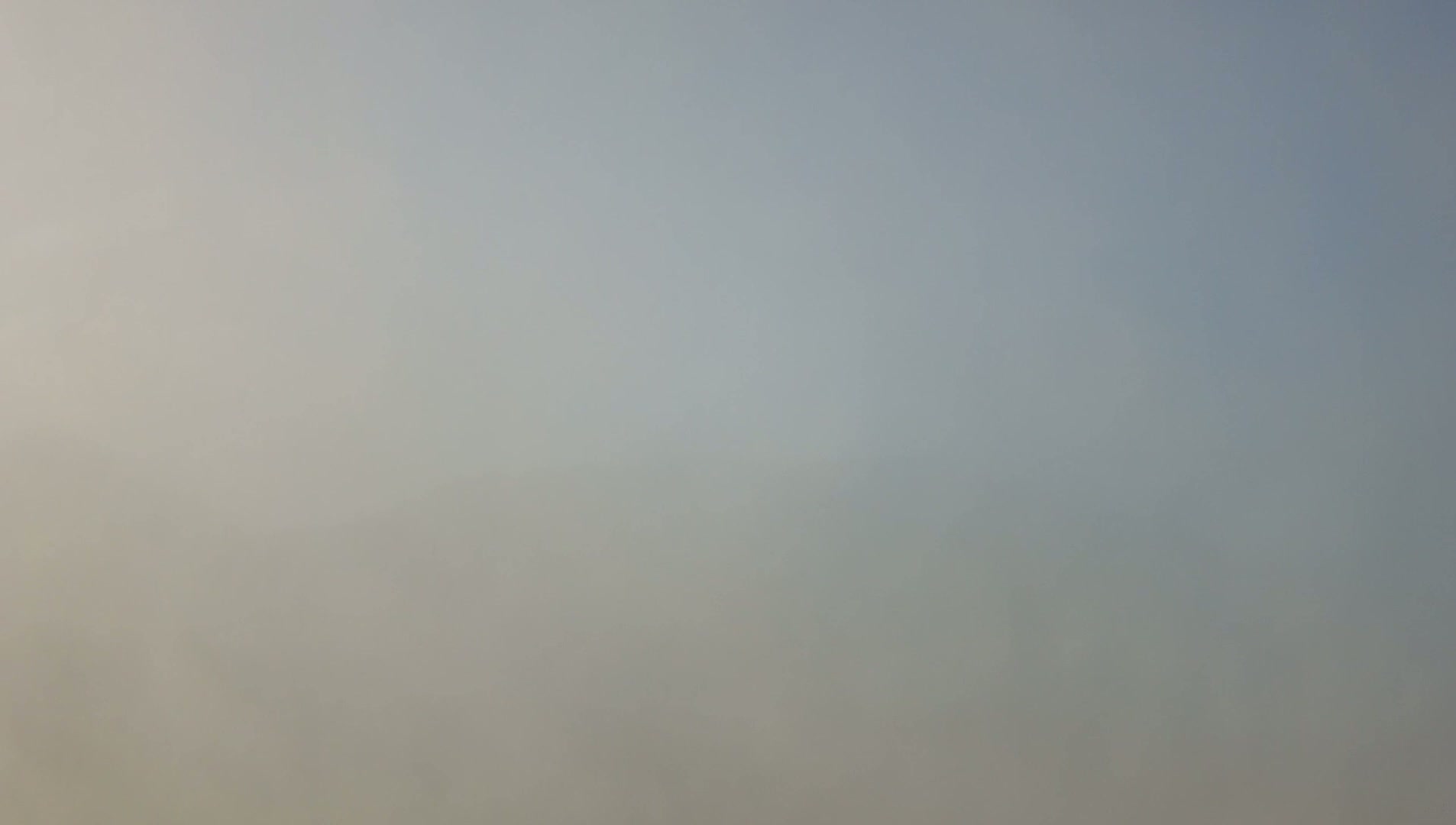 A hazy, light-grey sky is visible.