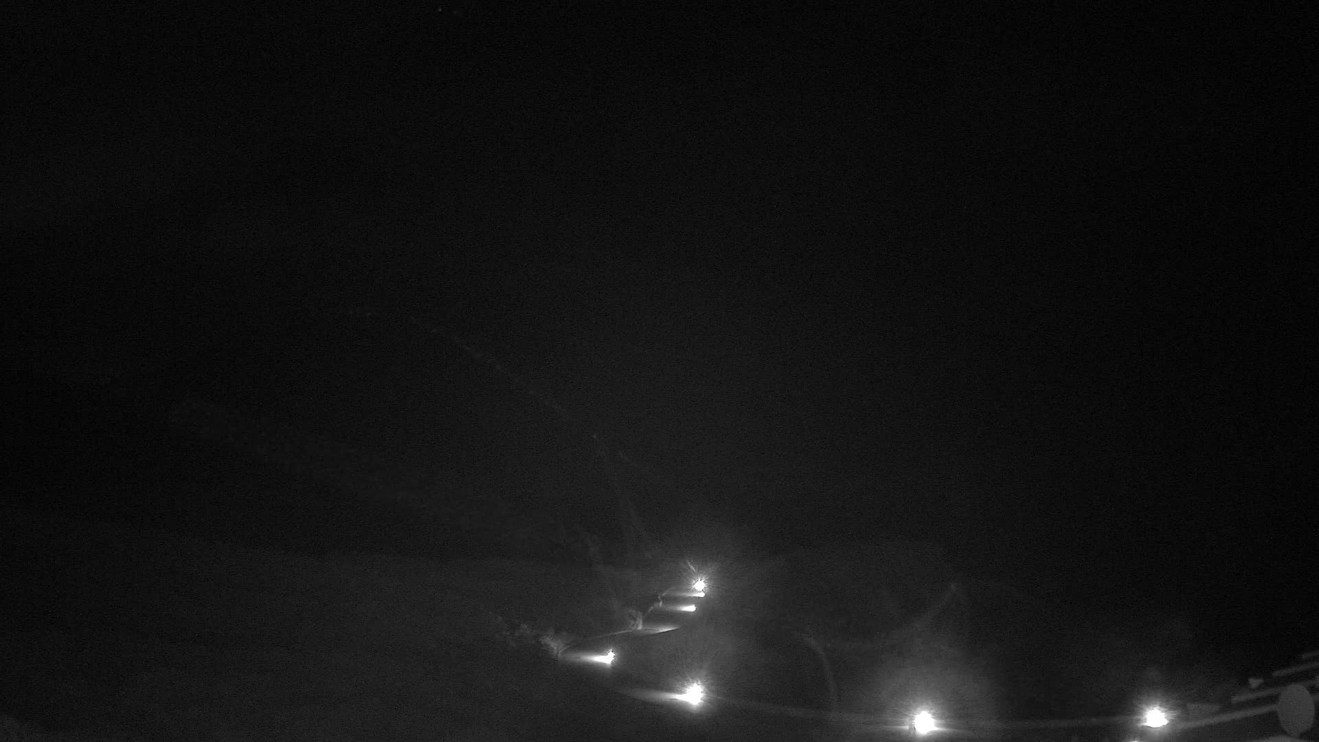 A very hazy outdoor landscape features a pale, indistinct sky blending into a slightly darker, brownish-grey ground, with extremely poor visibility.