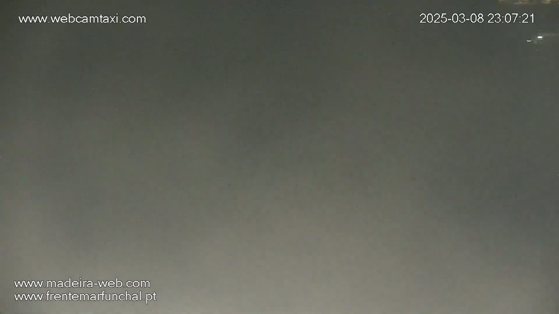 A uniformly dark gray, overcast sky is visible.