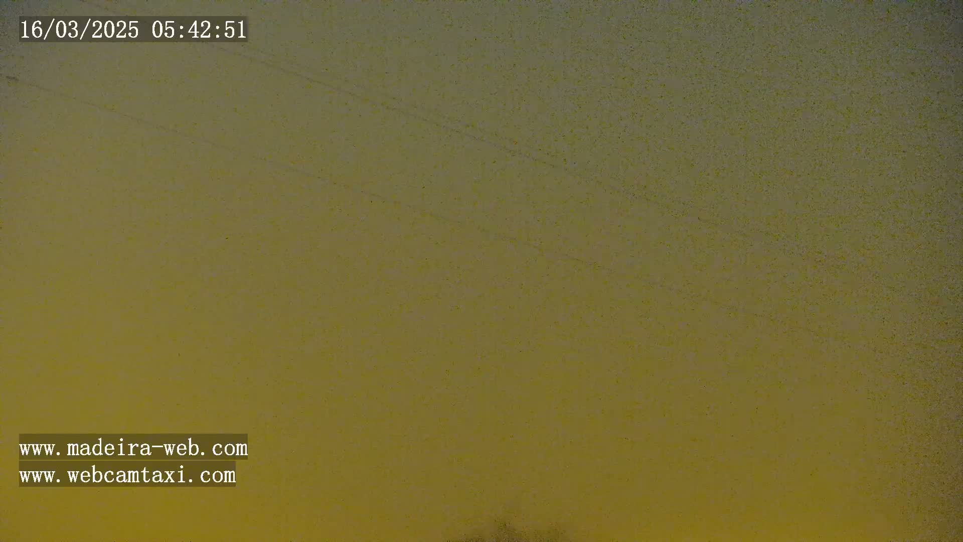 A muted yellow-brown sky is visible, possibly at dawn or dusk.