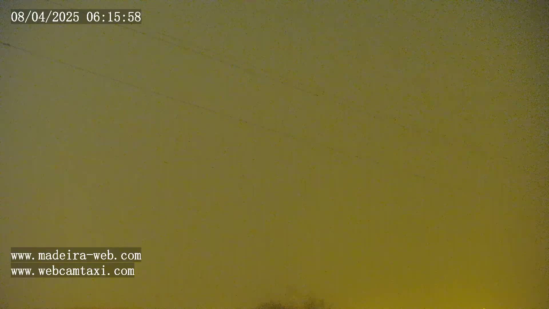 A muted olive-green sky is visible, possibly indicating an overcast or hazy morning.