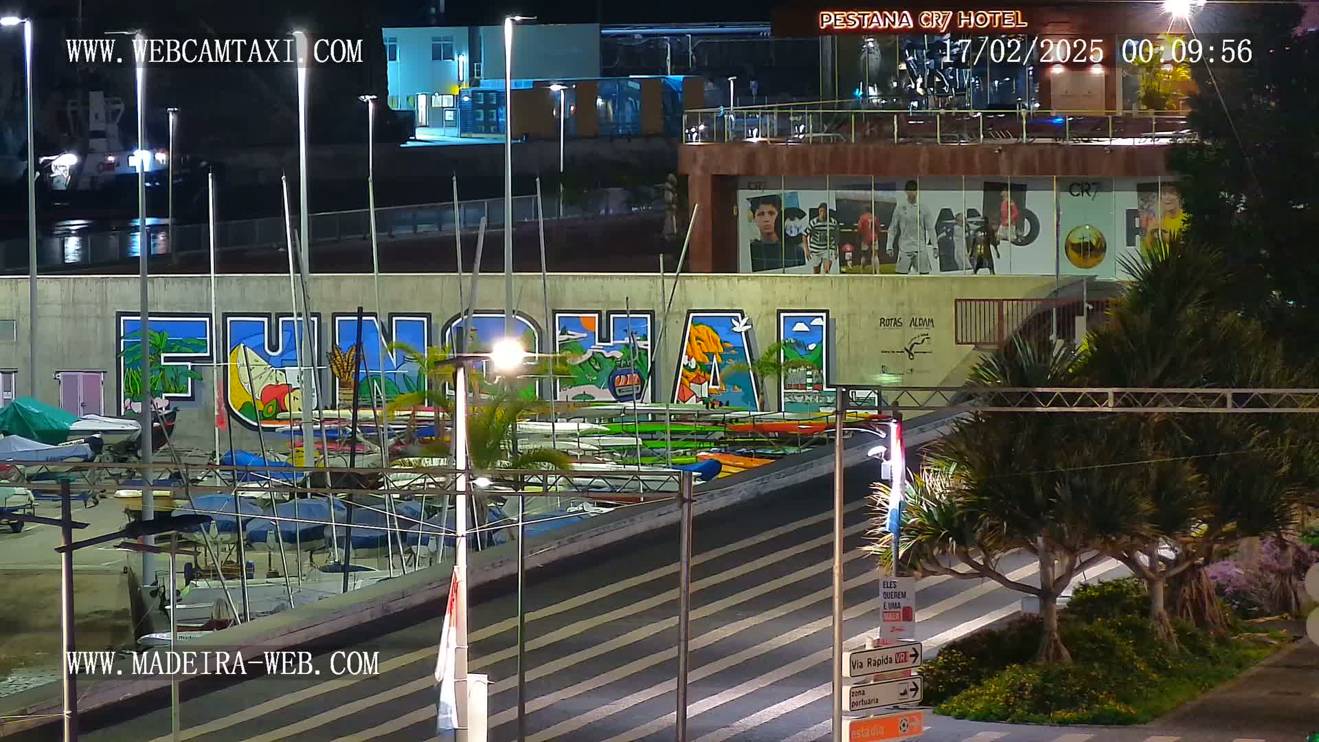 At night, a harbor scene shows a large mural of the word "FUNCHAL" on a wall above numerous boats and kayaks, with palm trees and streetlights illuminating the area.