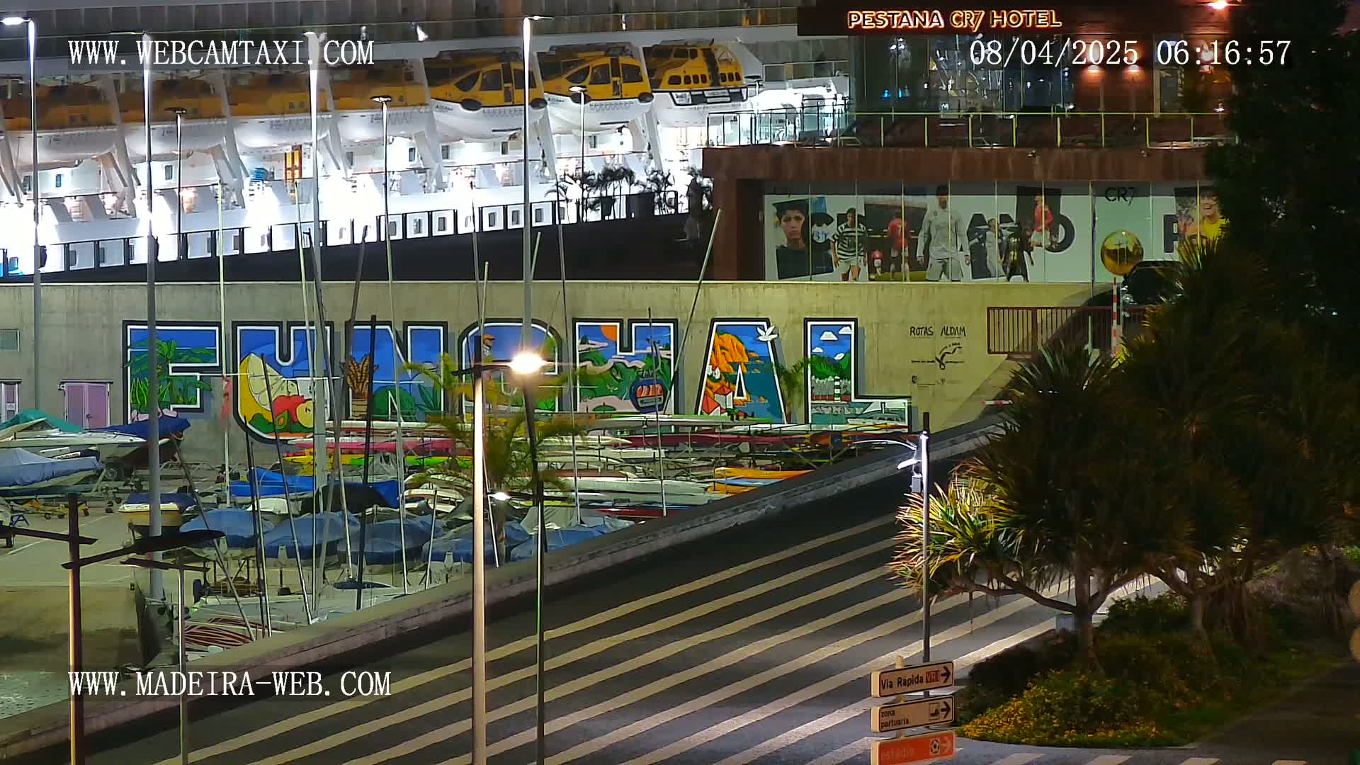 At night, a harbor scene shows numerous small boats docked below a large mural depicting the word "FUNCHAL," with a cruise ship and hotel visible in the background.