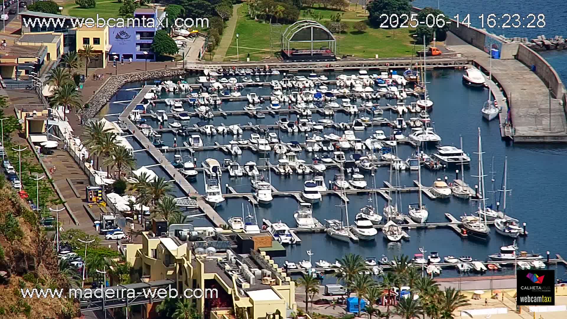 A marina filled with numerous boats and yachts on a sunny day.