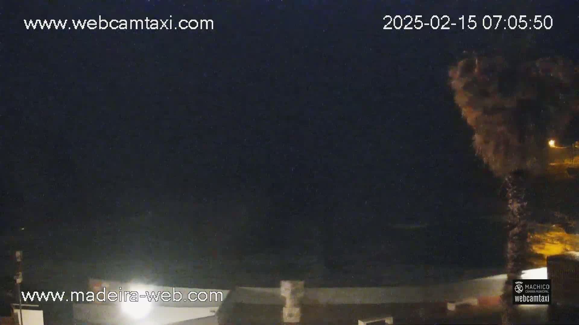 A nighttime, dark scene shows a dark, possibly stormy sky with a large, dark mass obscuring part of the view, possibly clouds or smoke.