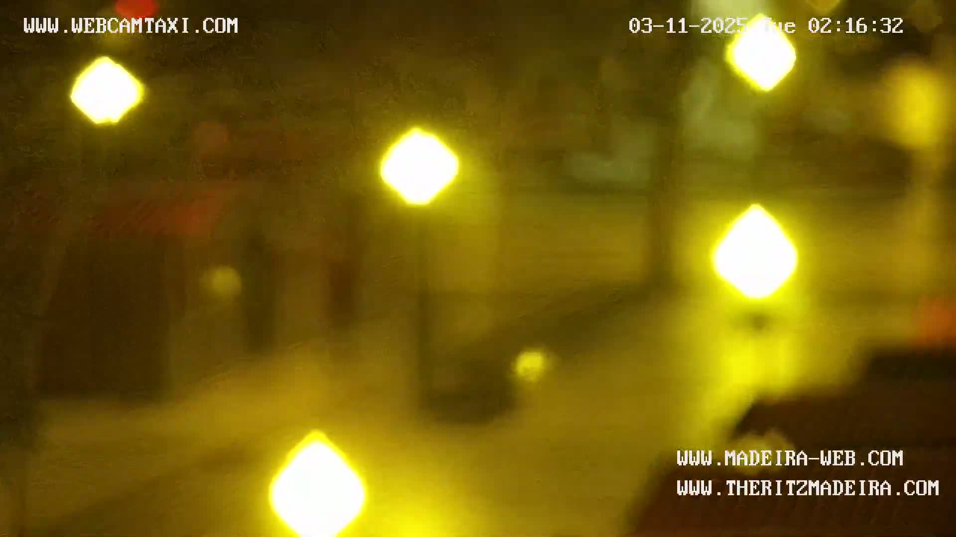 Blurry, out-of-focus nighttime image showing yellow lights.