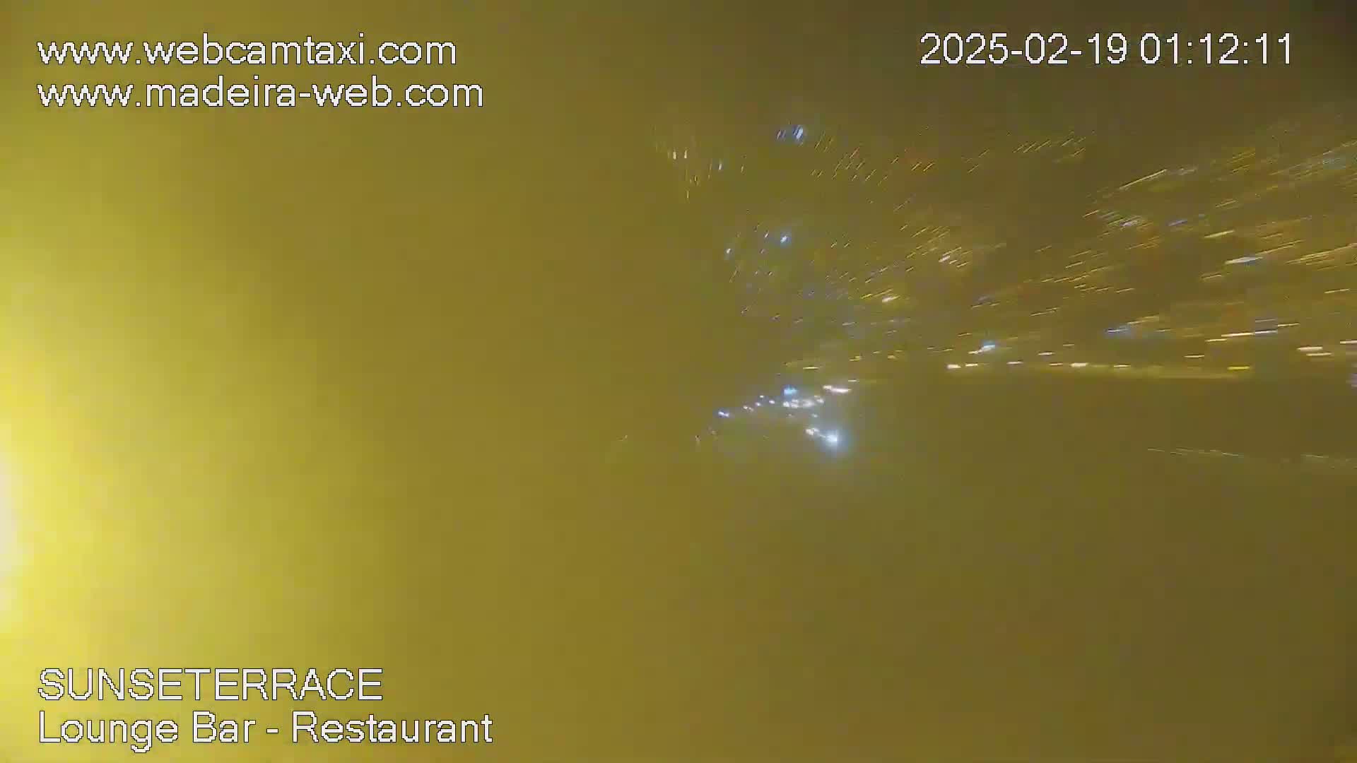 A hazy night scene shows blurred streaks of light from distant vehicles.