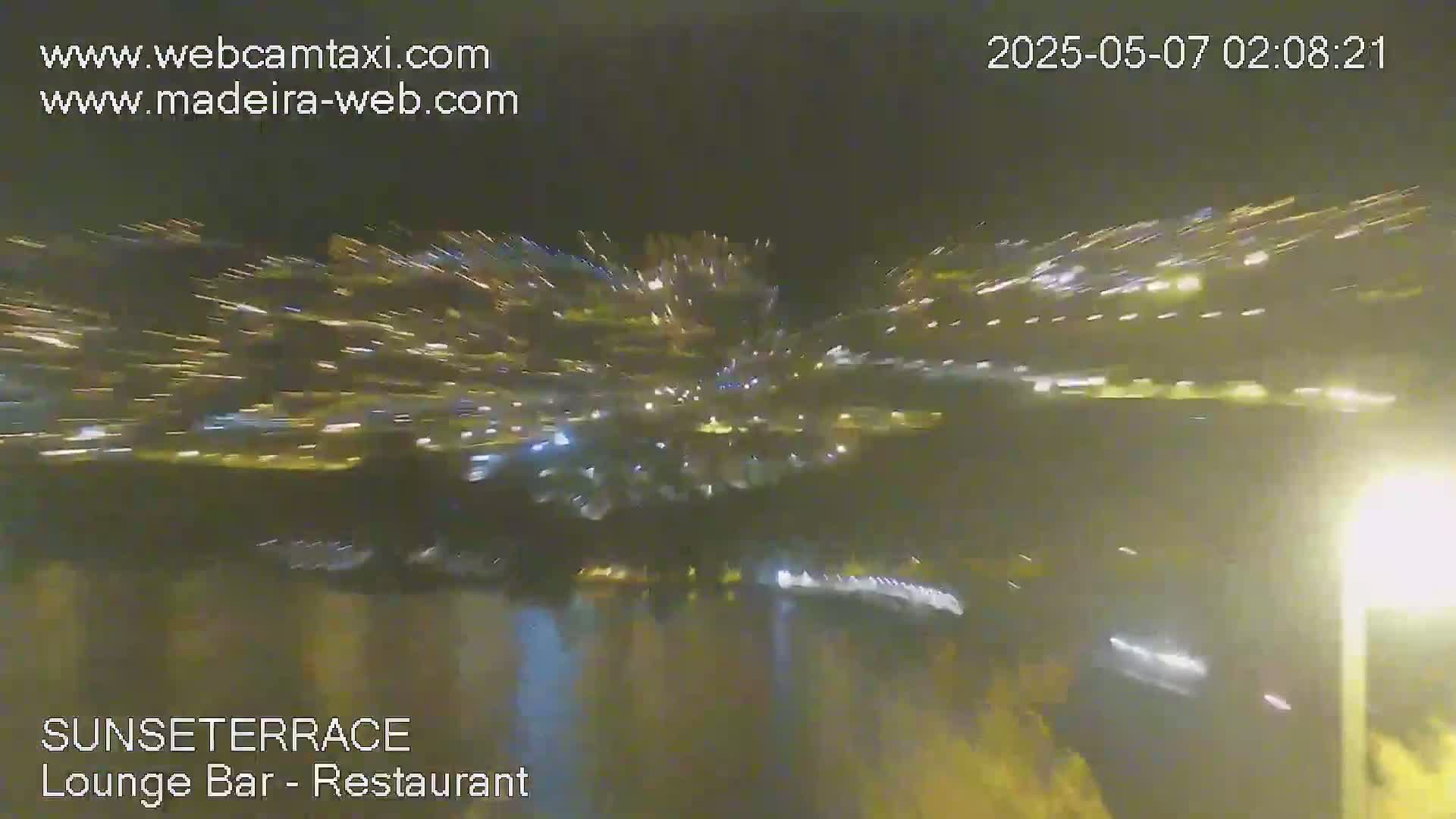 A nighttime, blurry view shows a burst of light streaks radiating outwards from a central point.