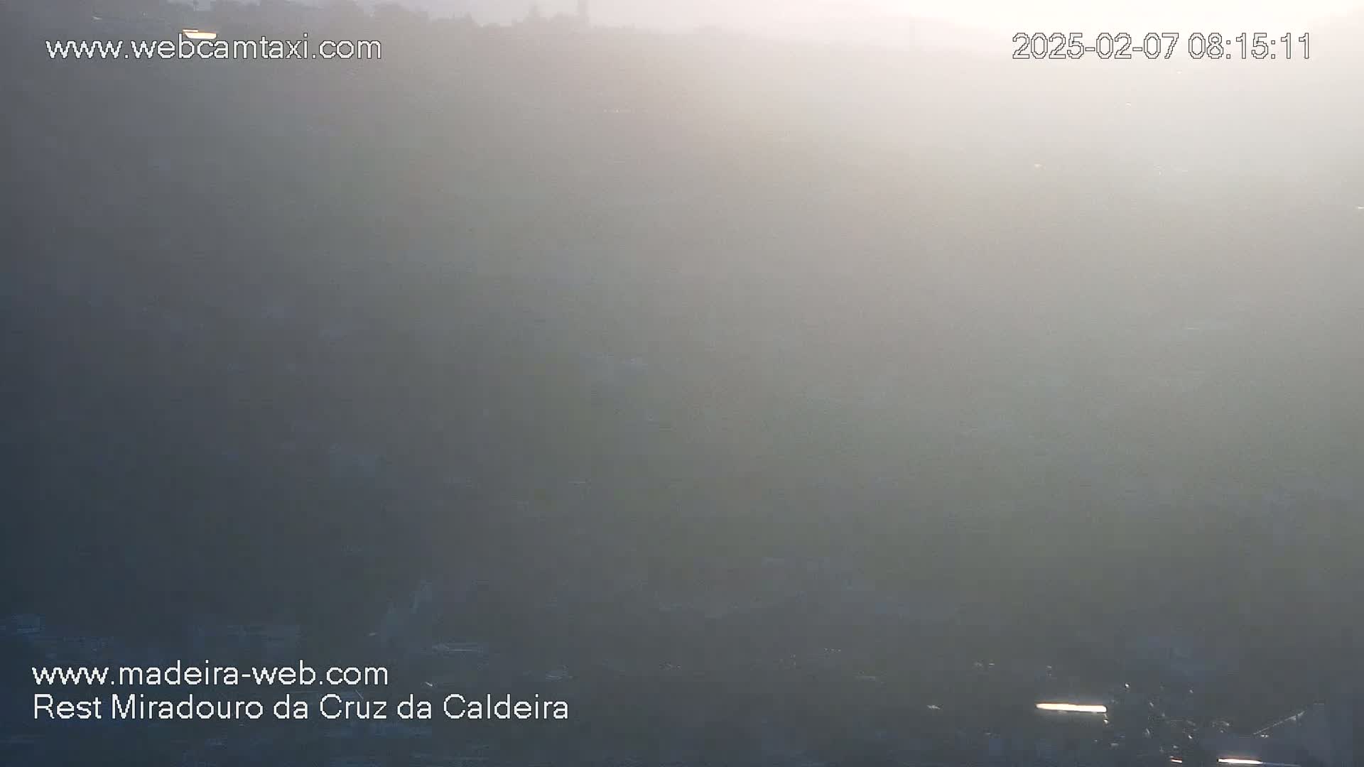 A hazy, foggy landscape is visible at dawn or dusk.