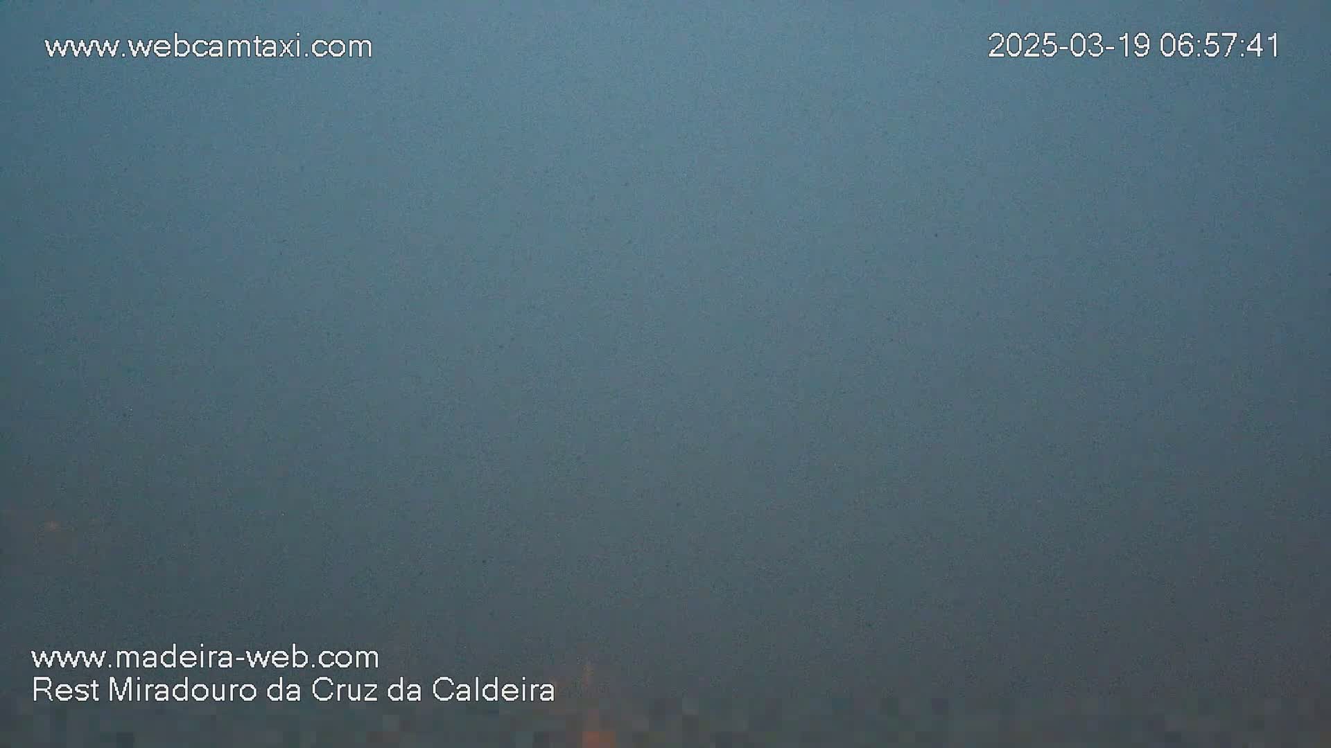 A hazy, gray sky is visible.