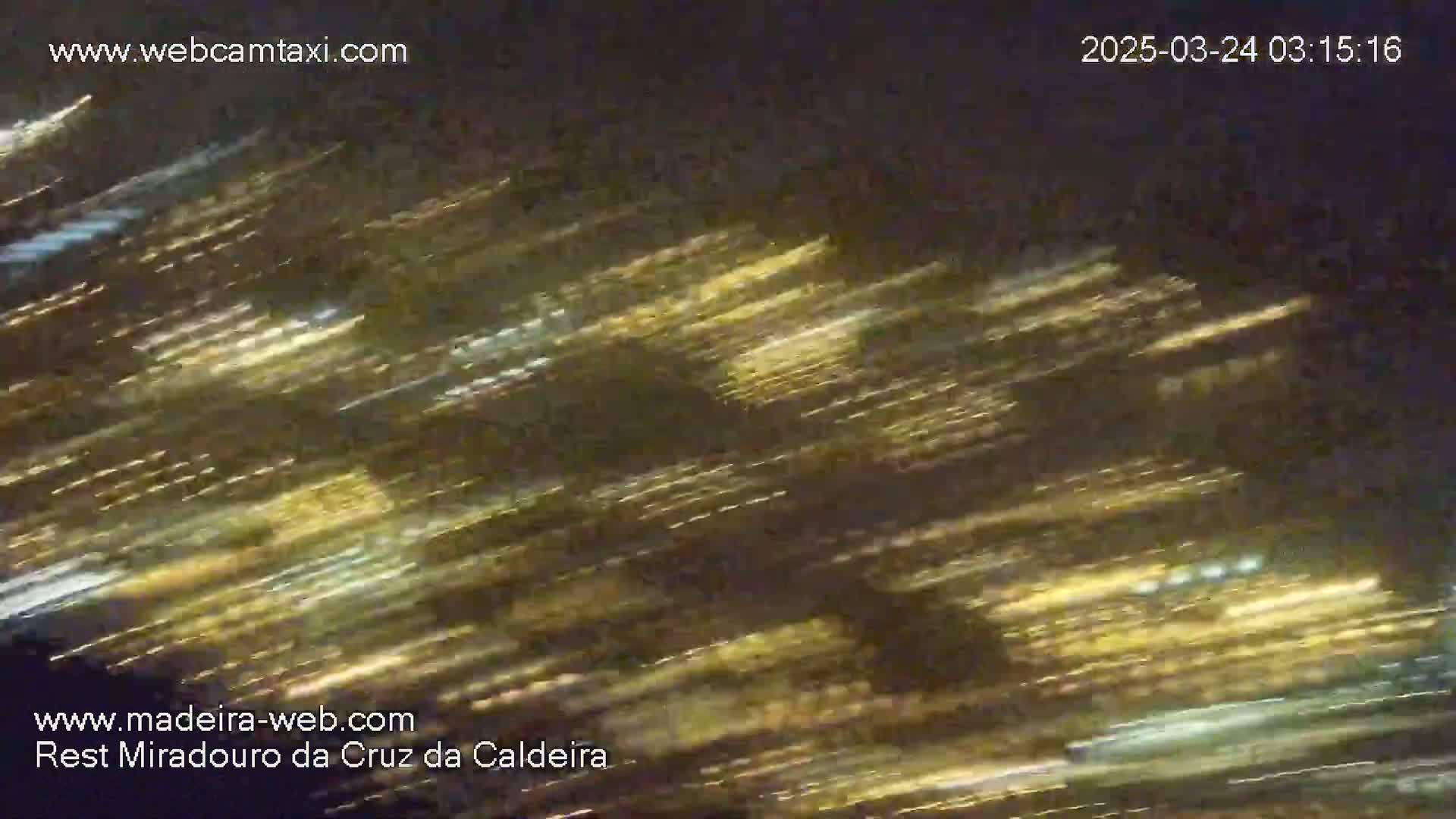 A long exposure nighttime shot shows streaks of light, likely from moving vehicles, against a dark background.