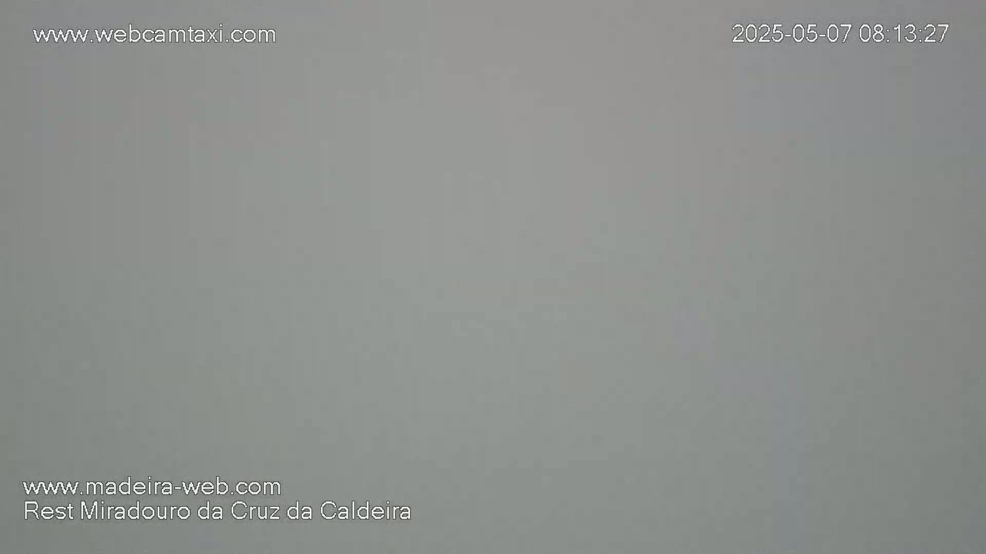 A uniformly light gray image shows an overcast sky.