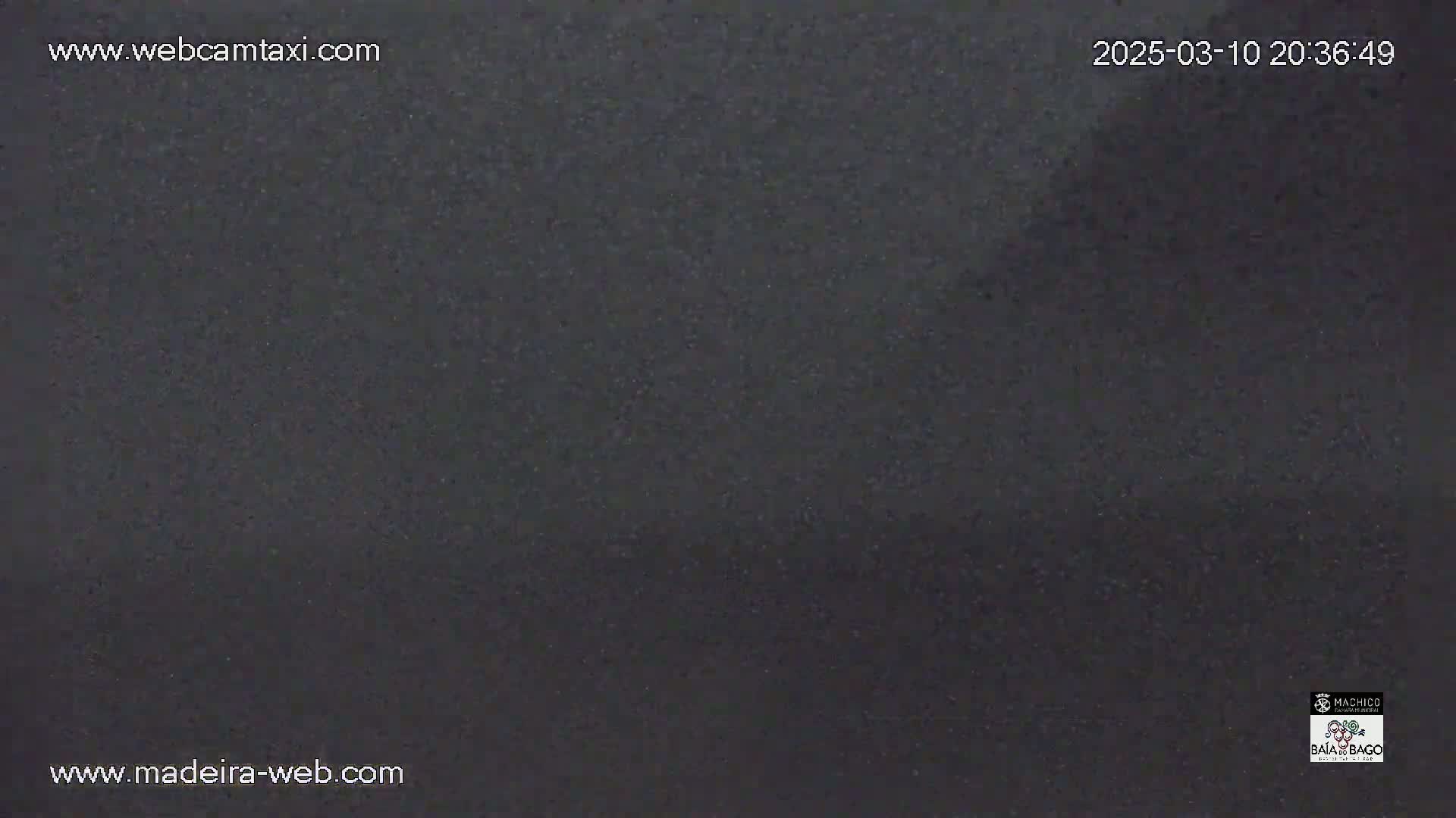 A dark gray or black surface, possibly asphalt, is shown under nighttime conditions.