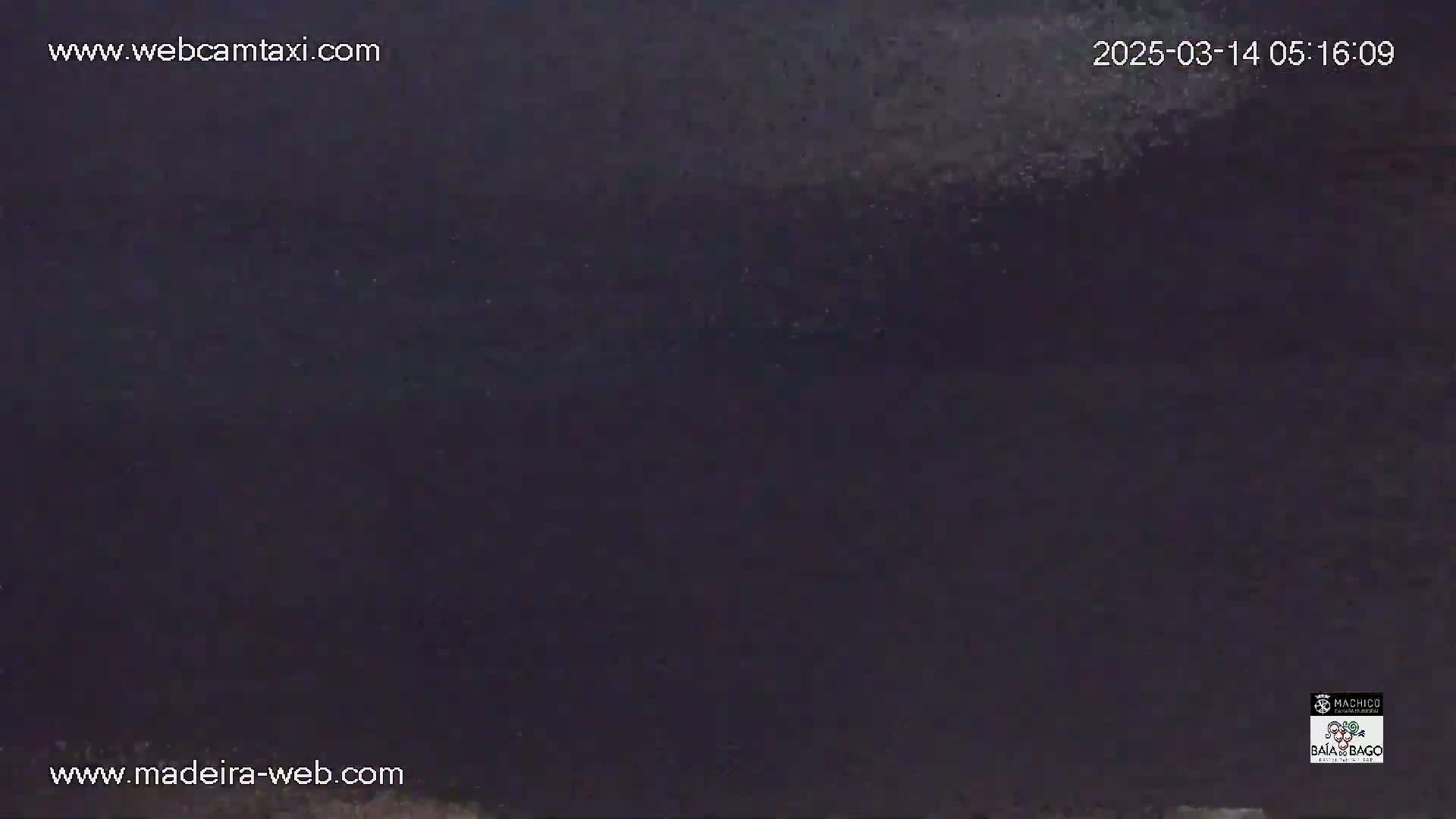 A dark, nighttime scene shows a mostly featureless, dark gray sky.