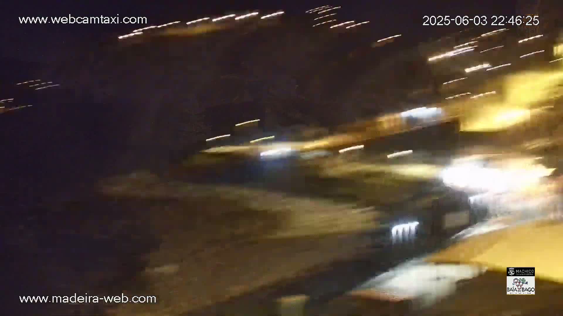 Blurred nighttime images of vehicles and lights on a roadway.