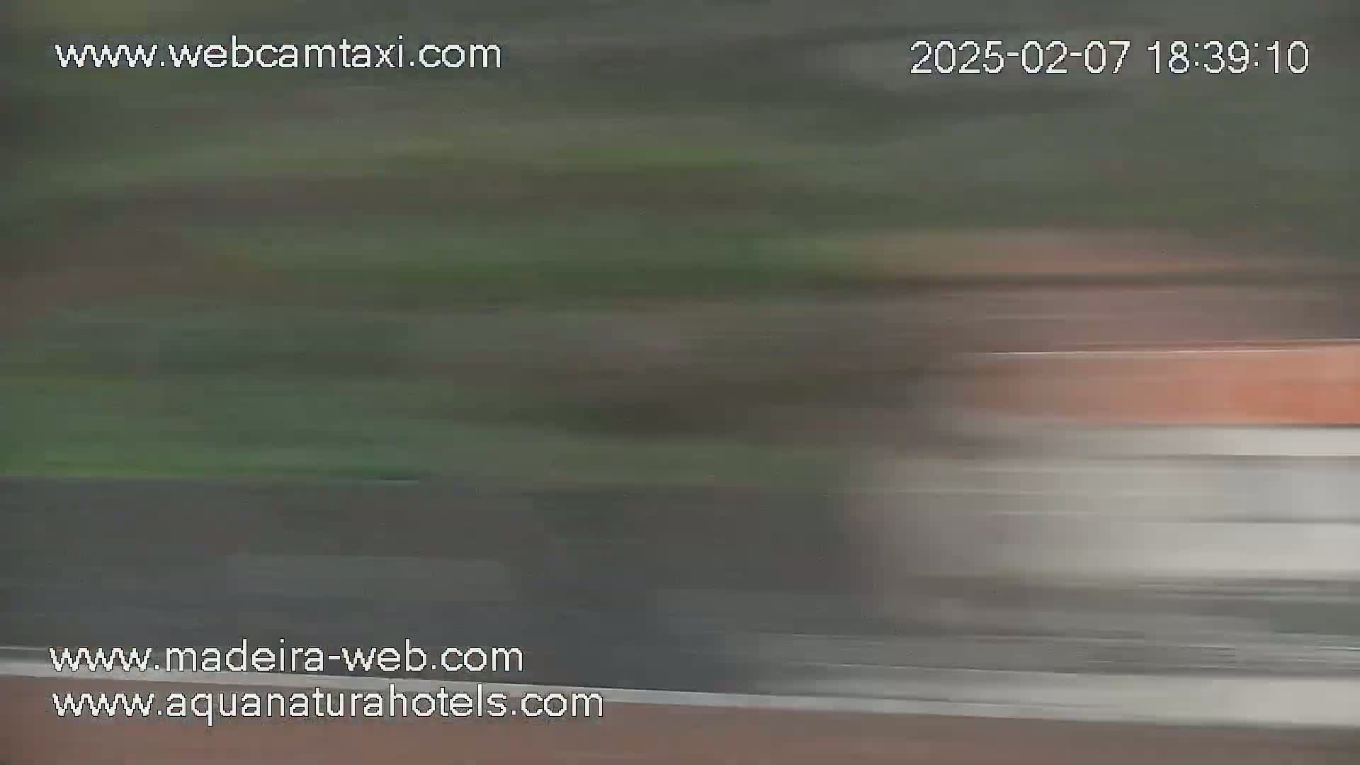 A blurry image shows a fast-moving vehicle, possibly a train or car, passing by.