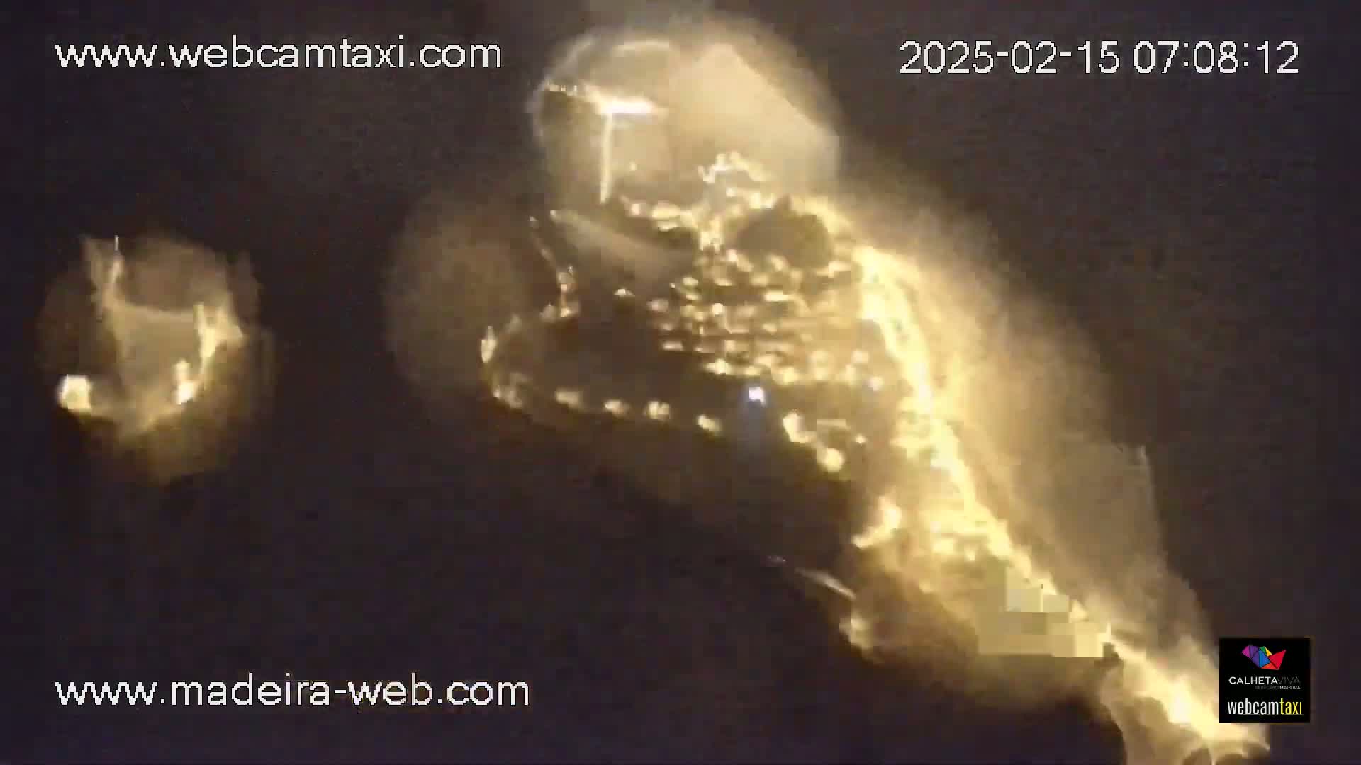 A blurry, bright yellow object, possibly a vehicle, is shown at night.