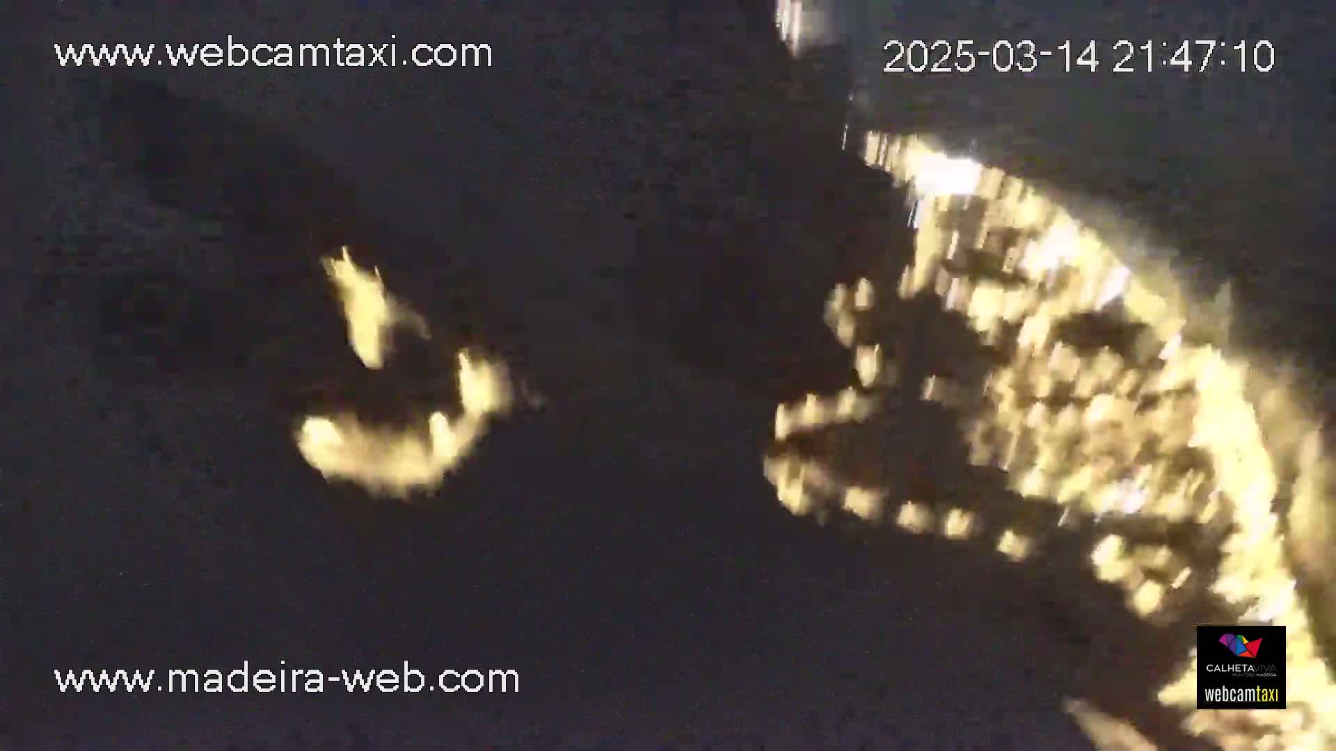 A nighttime image shows blurry, bright yellow lights in the distance, possibly city lights, against a dark background.