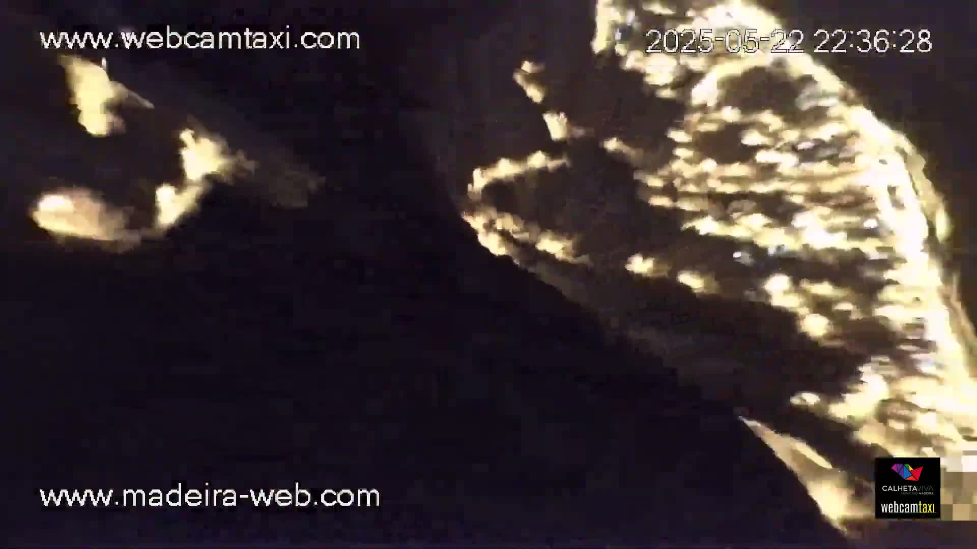 A nighttime, blurry image shows bright, glowing patches of light against a dark background.