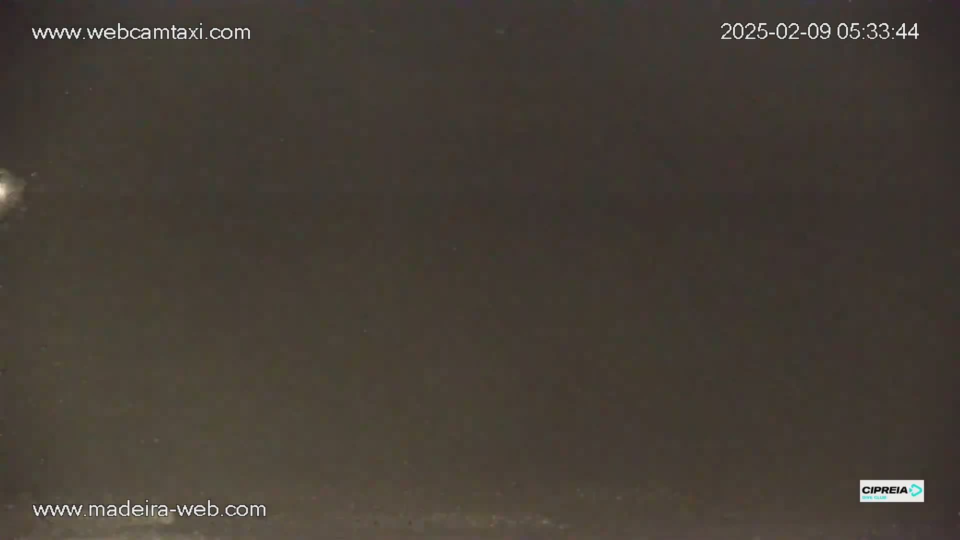 A dark, nighttime scene shows a mostly featureless, dark gray expanse.