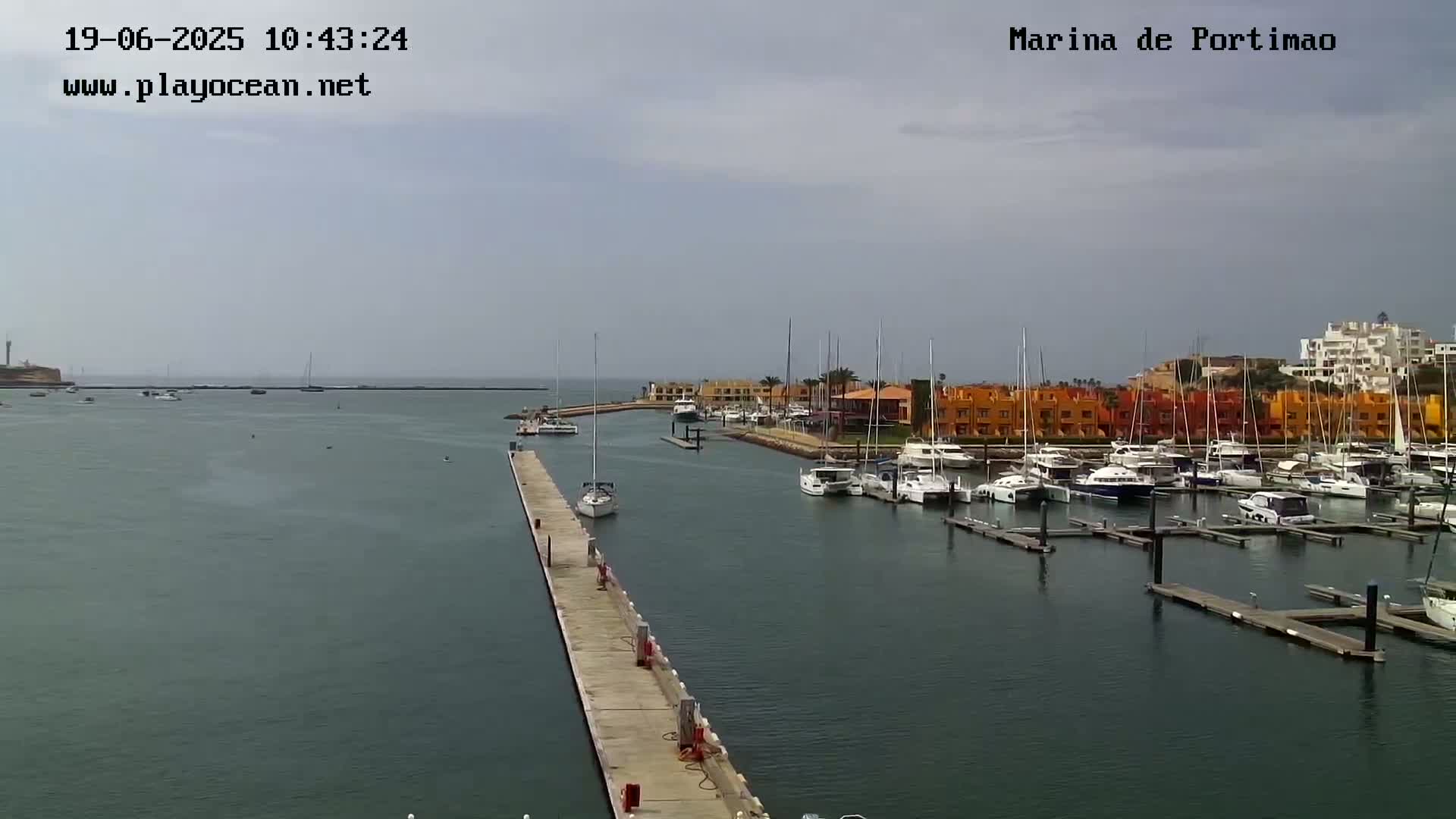 A marina filled with boats on a cloudy day.